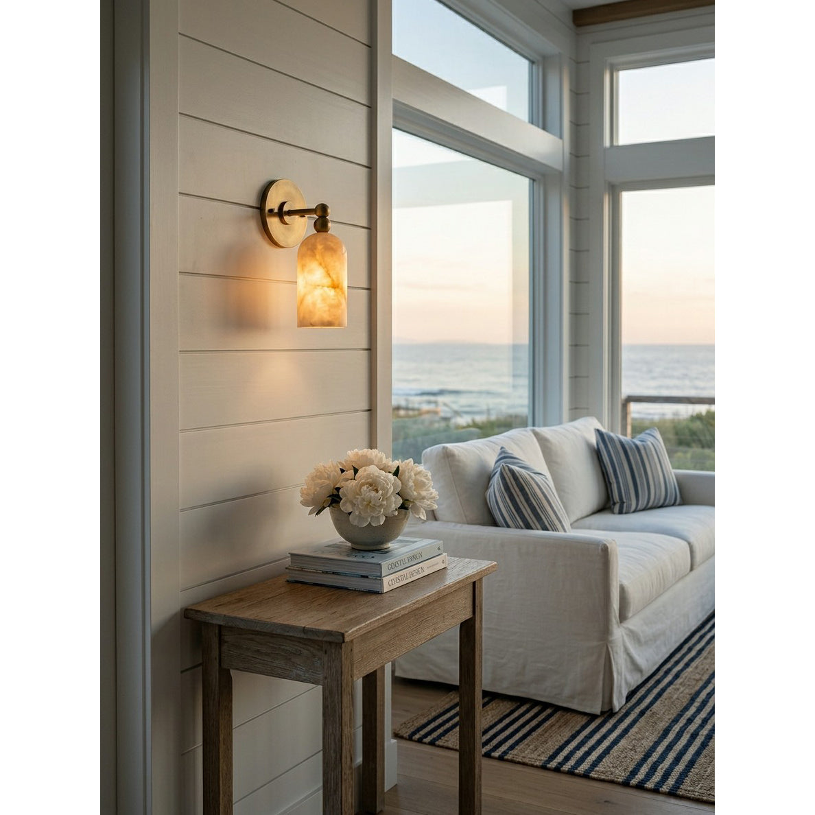 A pair of Pratt Alabaster Wall Sconces installed on either side of a bathroom mirror.