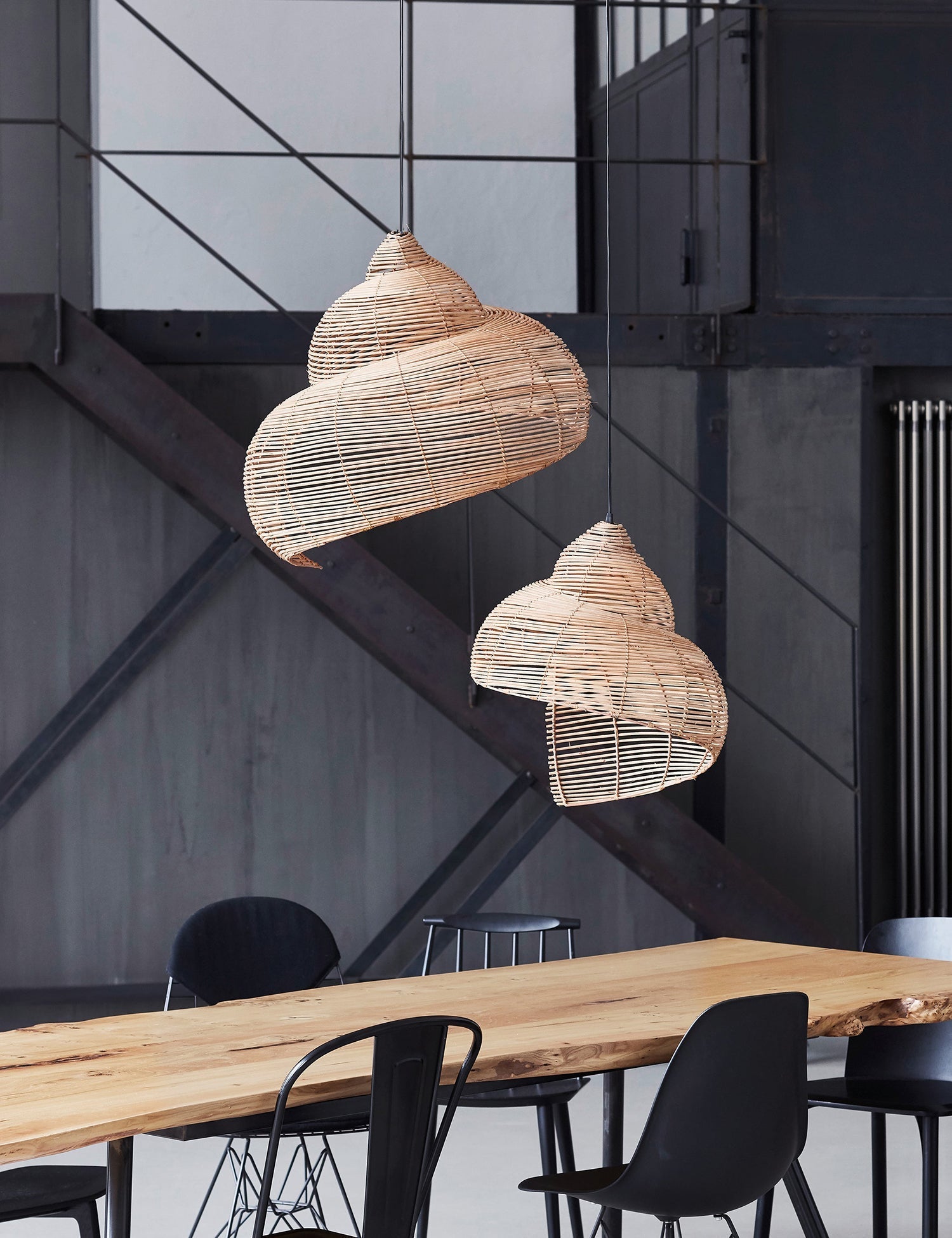 Close-up view of the hand-woven rattan texture on the spiral lamp.