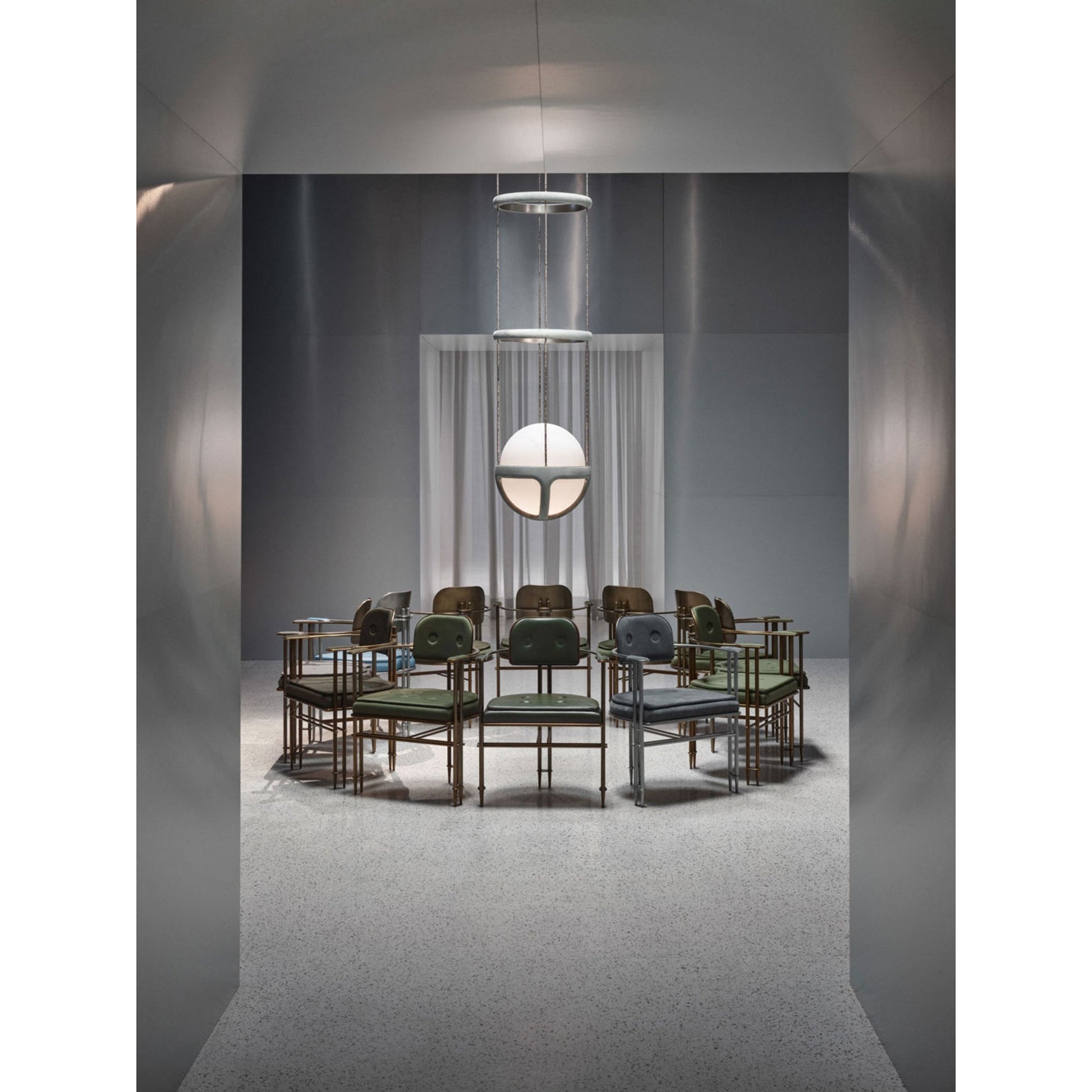 The pendant light against a dark, moody wall, emphasizing its design.
