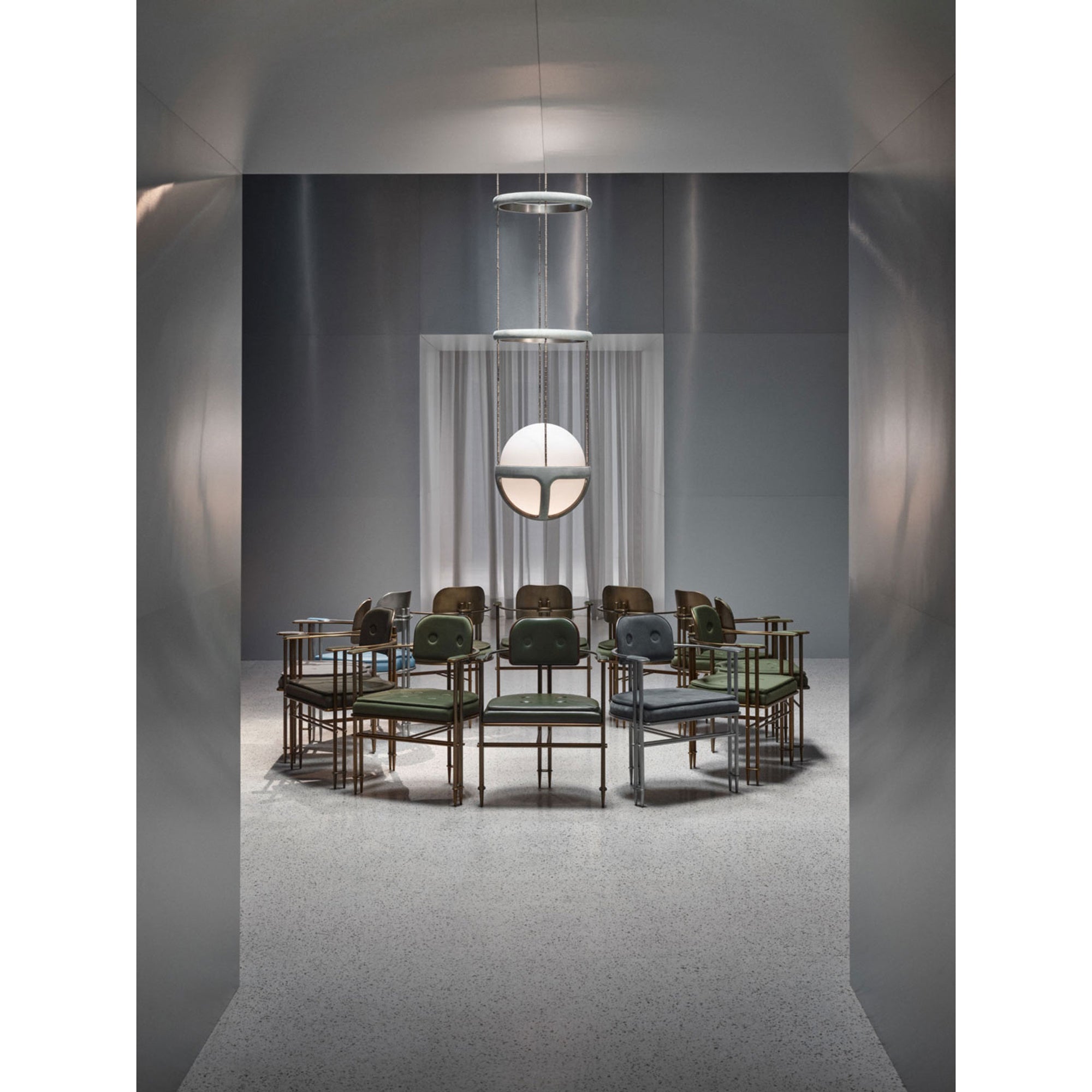 The pendant light against a dark, moody wall, emphasizing its design.