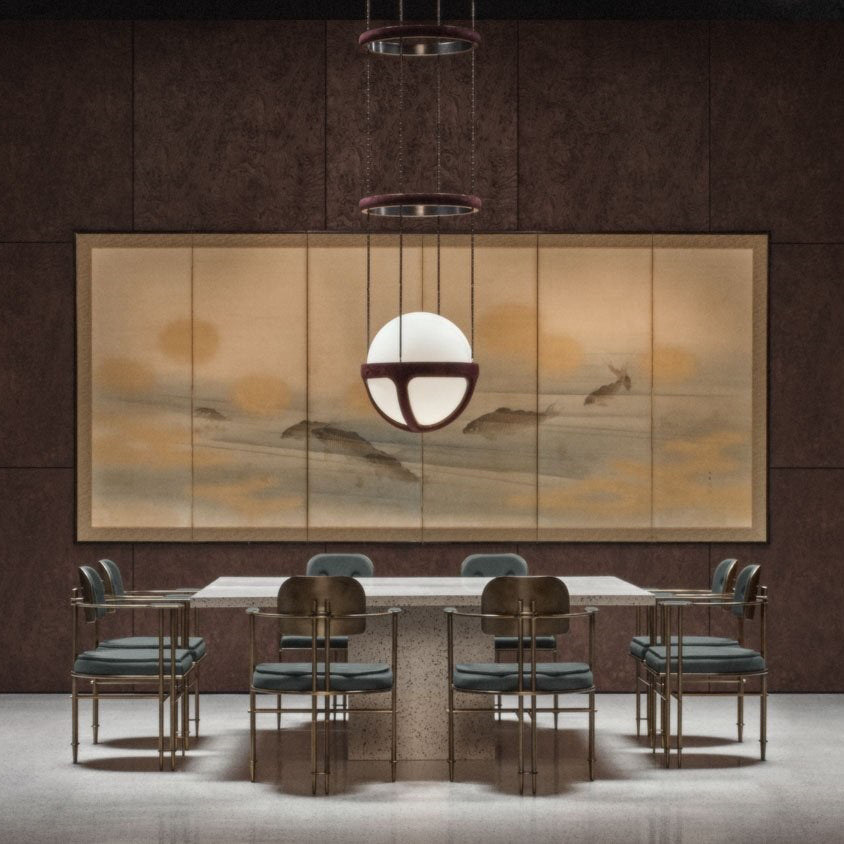 The white glass globe of the Reprise Pendant Lamp, shown illuminated.