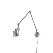 Reznor plug-in wall sconce in nickel finish, shown against a neutral wall.