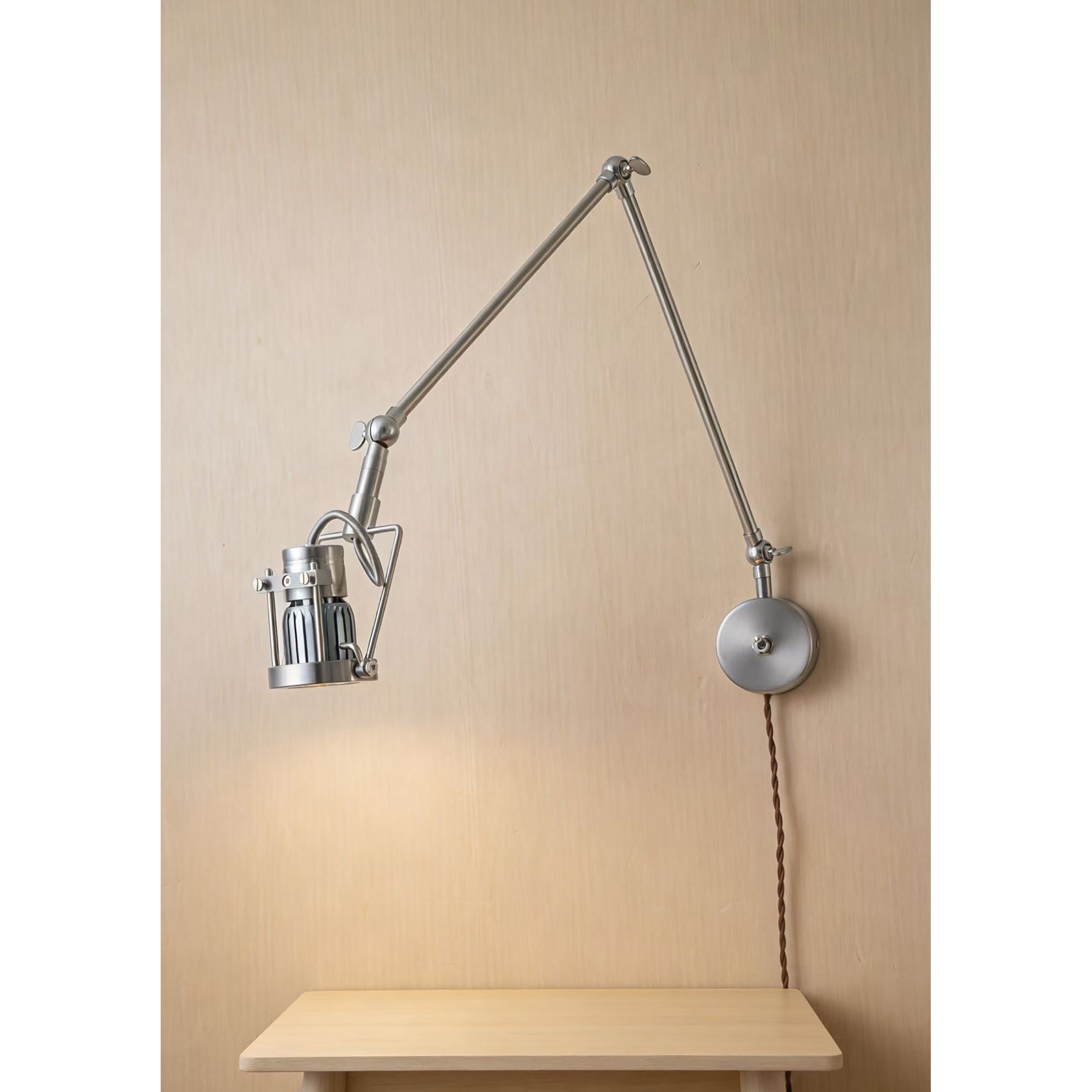 The sconce folded against the wall to show its compact form.