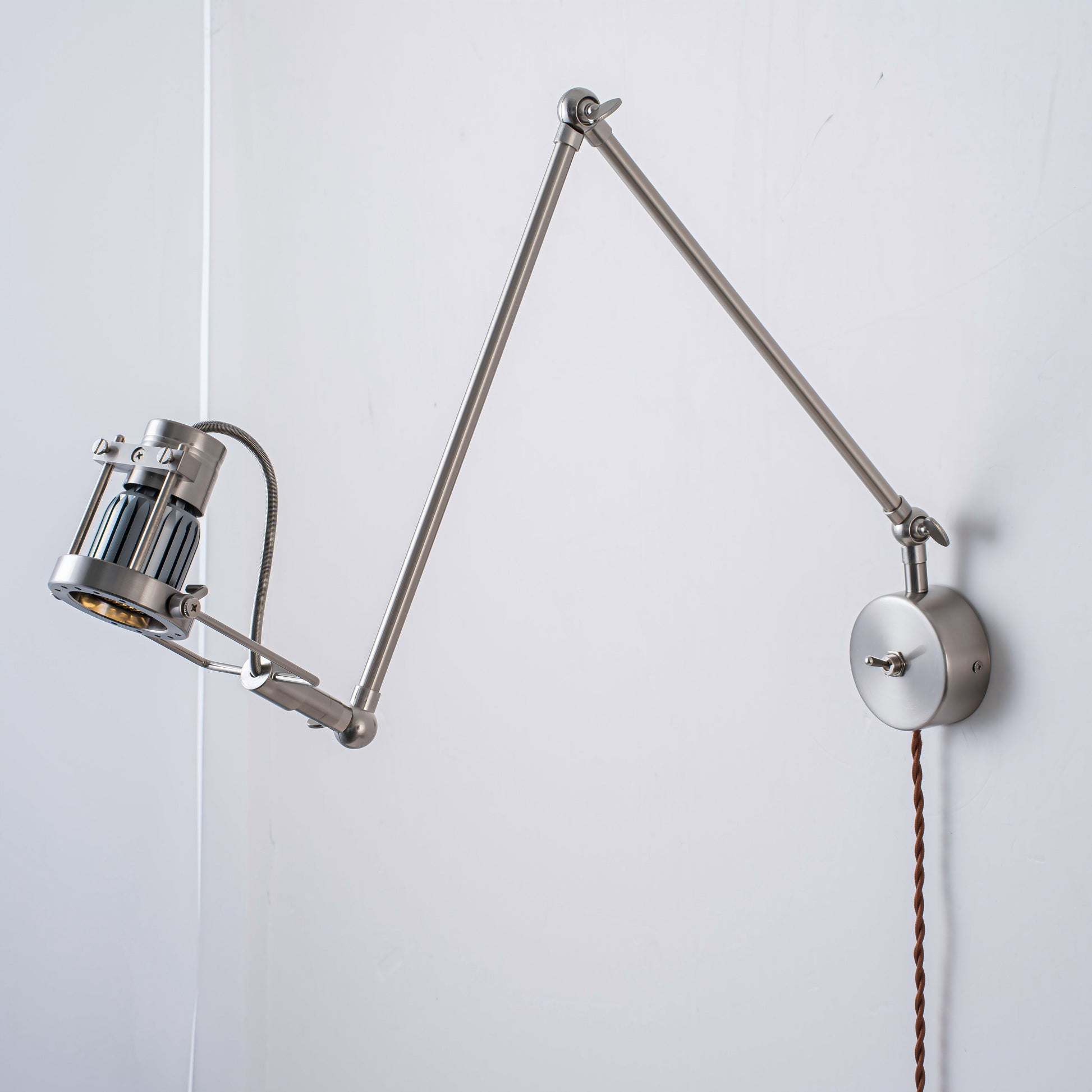 The Reznor sconce against a dark, textured wall for contrast.