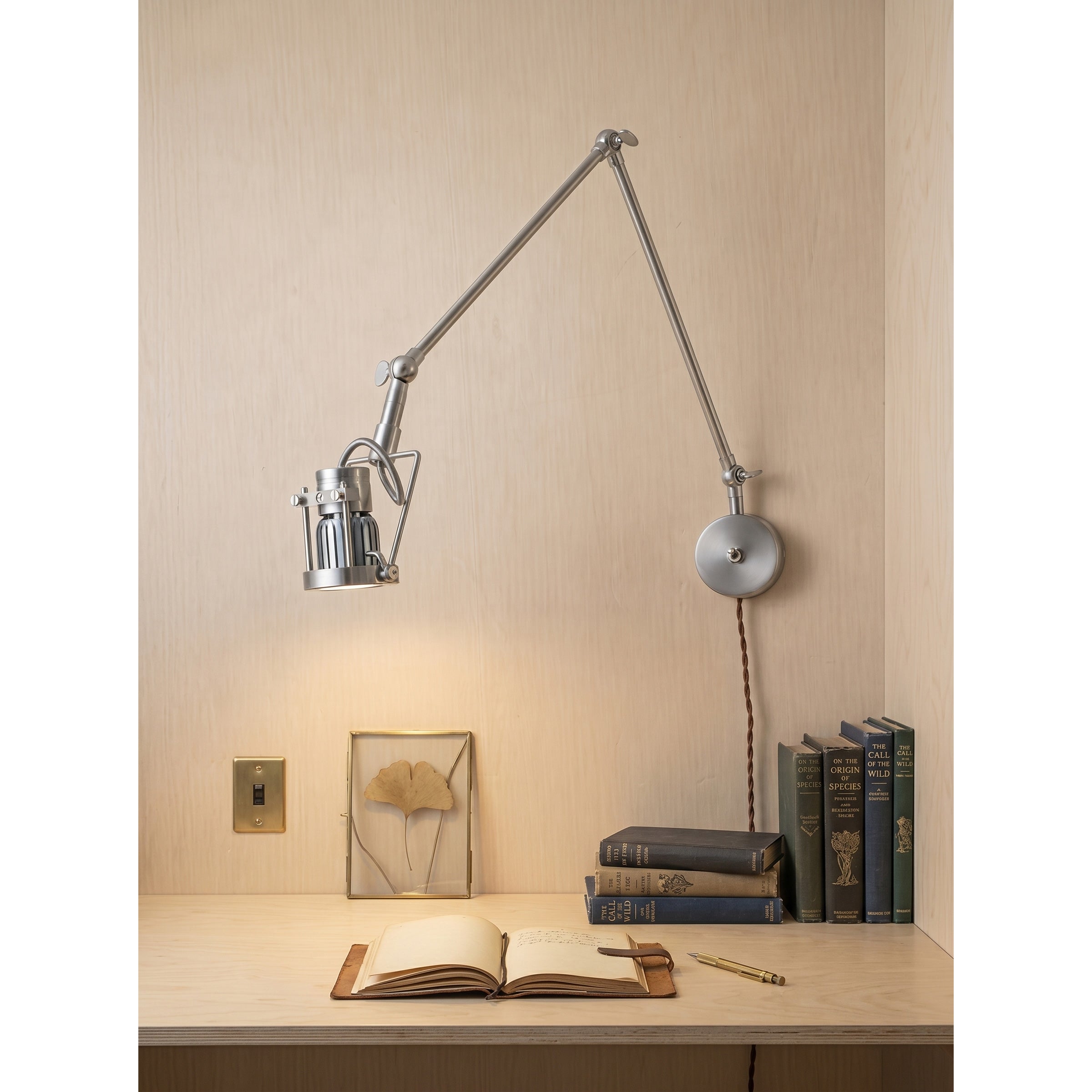 Angled view of the Reznor sconce, highlighting its vintage industrial design.