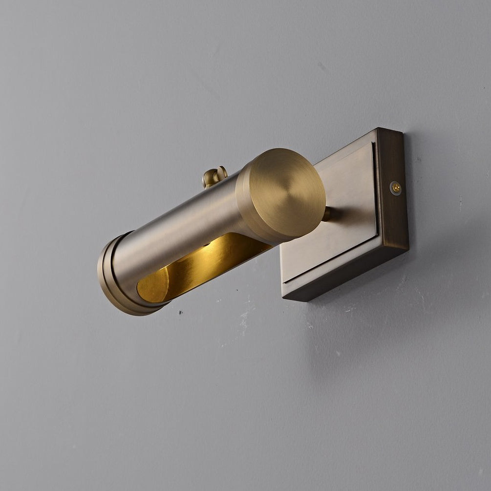 The sconce illuminating an open shelving unit.
