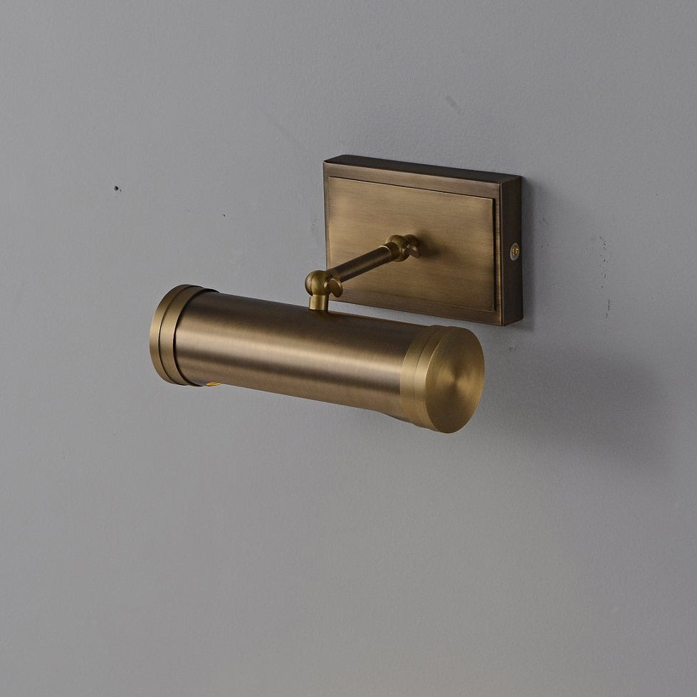 The sconce casting a warm, focused light downwards.