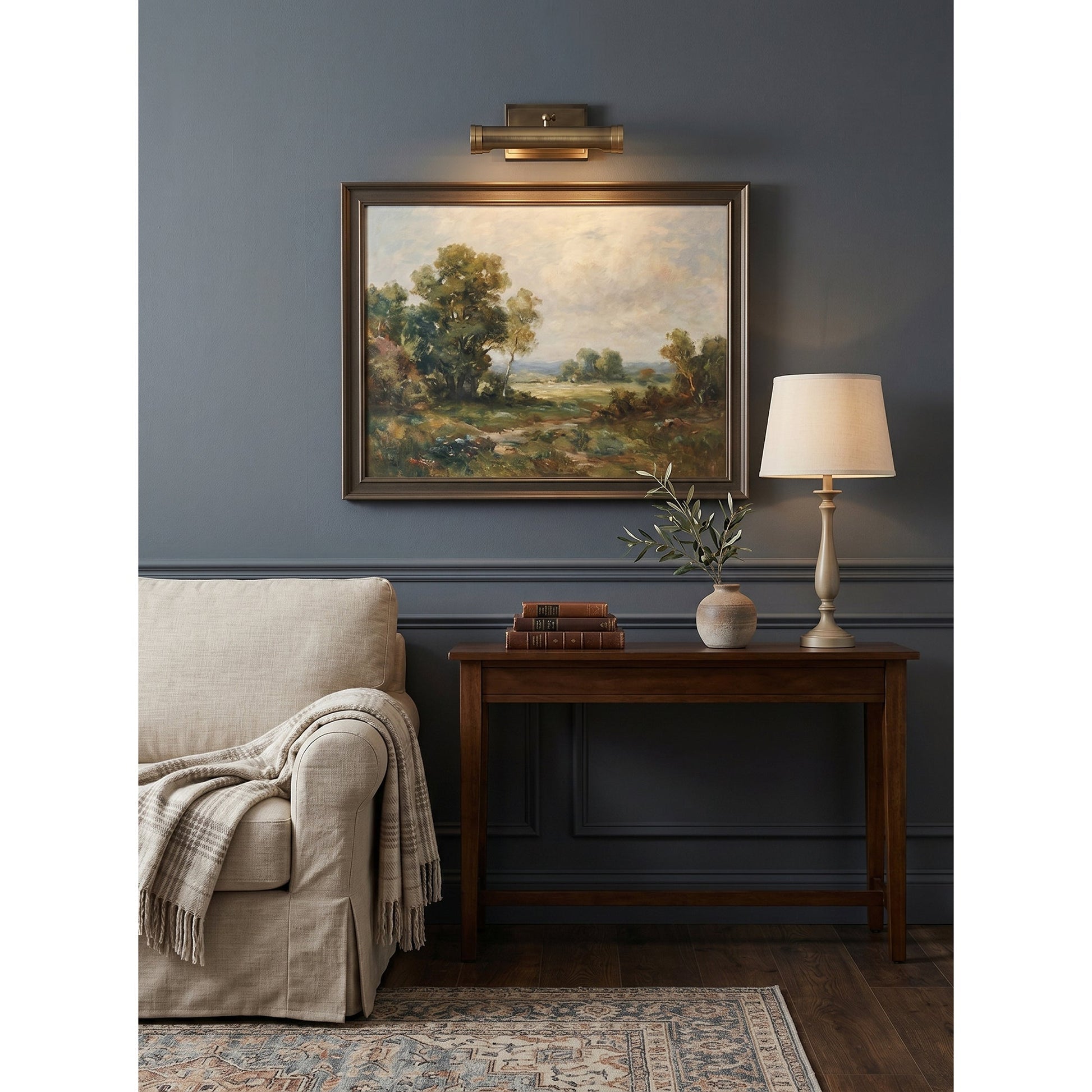 Ridgewood Wall Sconce installed above a painting in a living room.