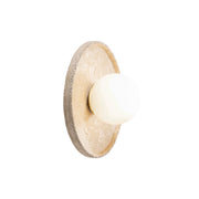 Riley Travertine Wall Sconce shown against a neutral wall.