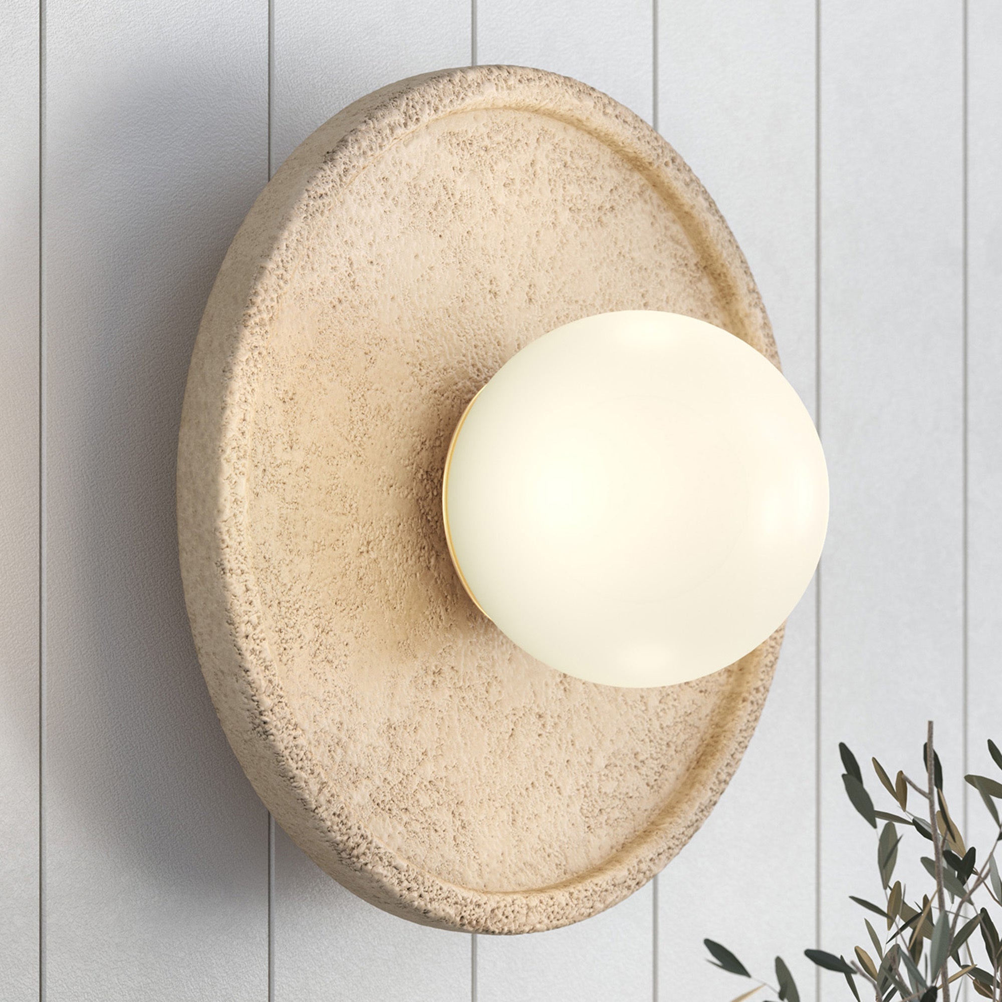 Close-up of the Riley Wall Sconce showing the natural travertine texture.