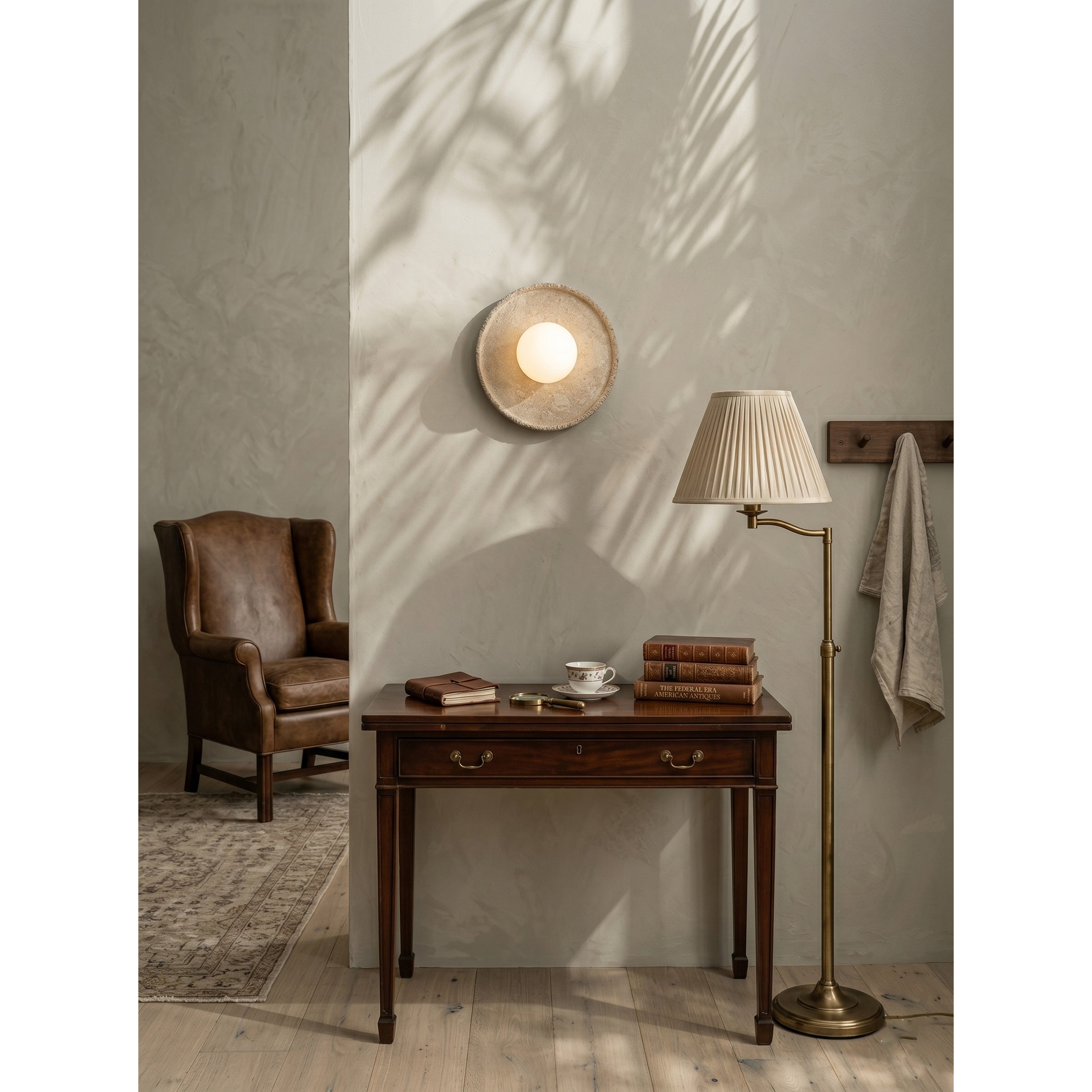 Angled view of the oval-stadium shaped travertine wall light.