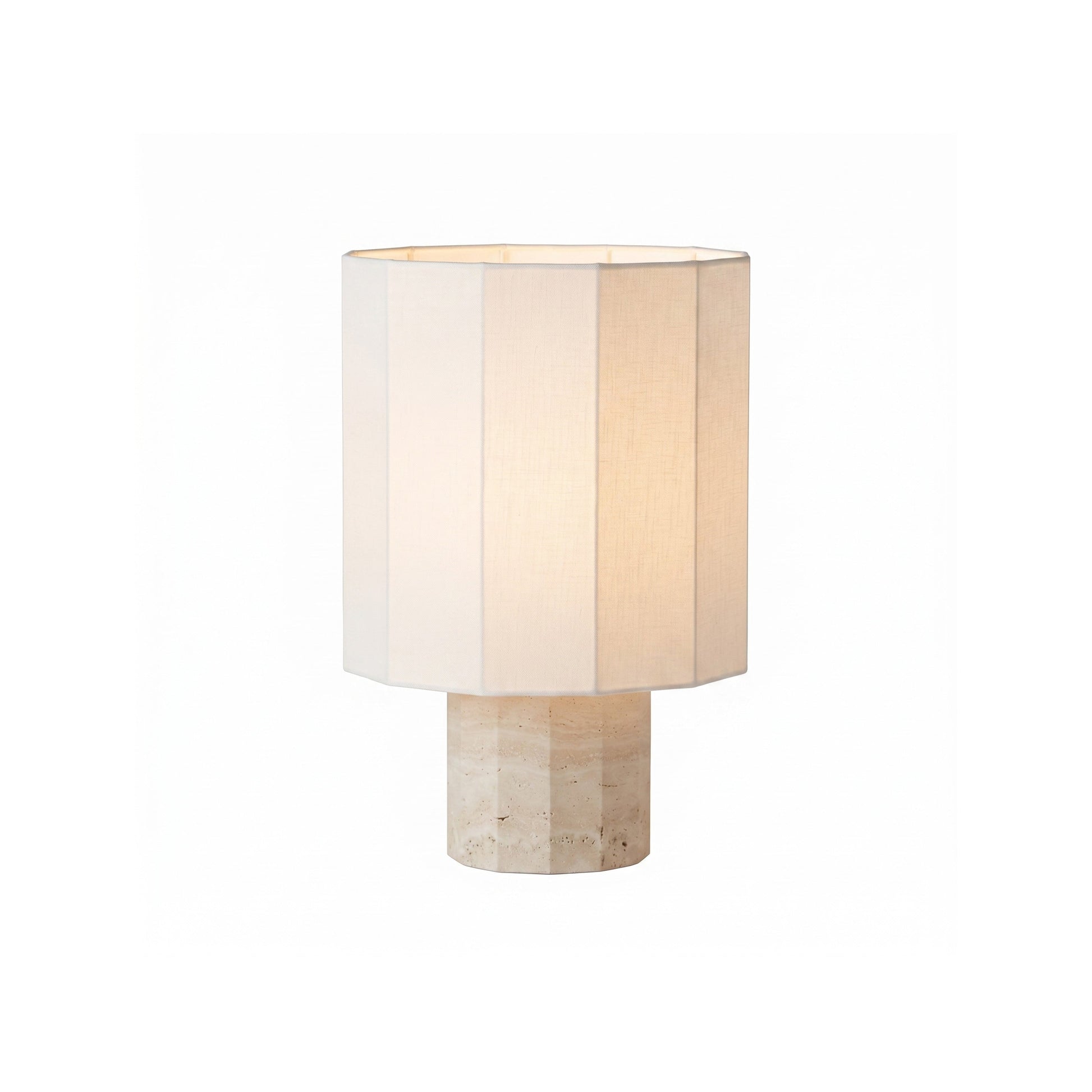 Roma Dodecagon Travertine Table Lamp with a navy blue shade on a surface.