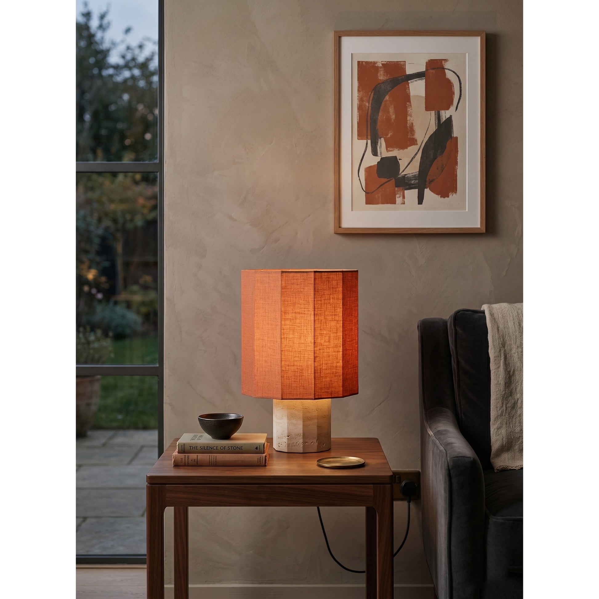 Lifestyle image of the lamp creating mood lighting in a dark room.