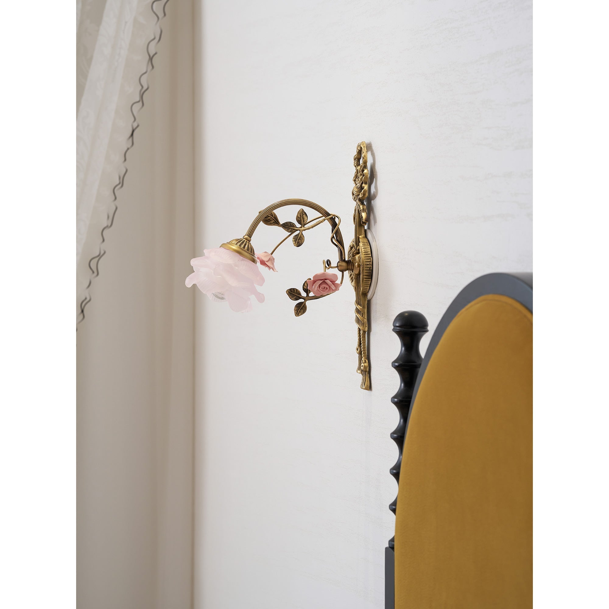 Rosalie Floral Wall Lamp, lit in a room.