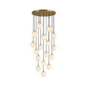 Savina Alabaster Chandelier with multiple glowing globes hanging in a grand entryway.