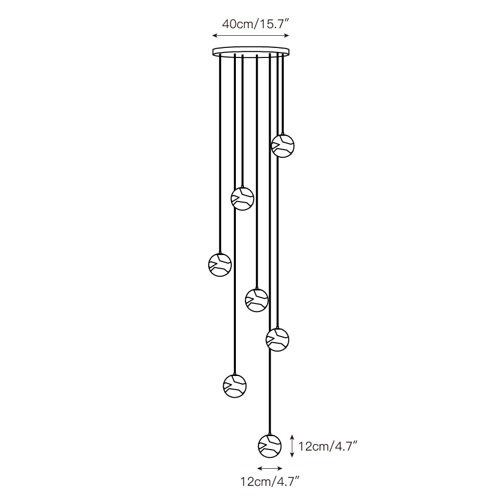 The cascading silhouette of the Savina Chandelier against a dark wall.