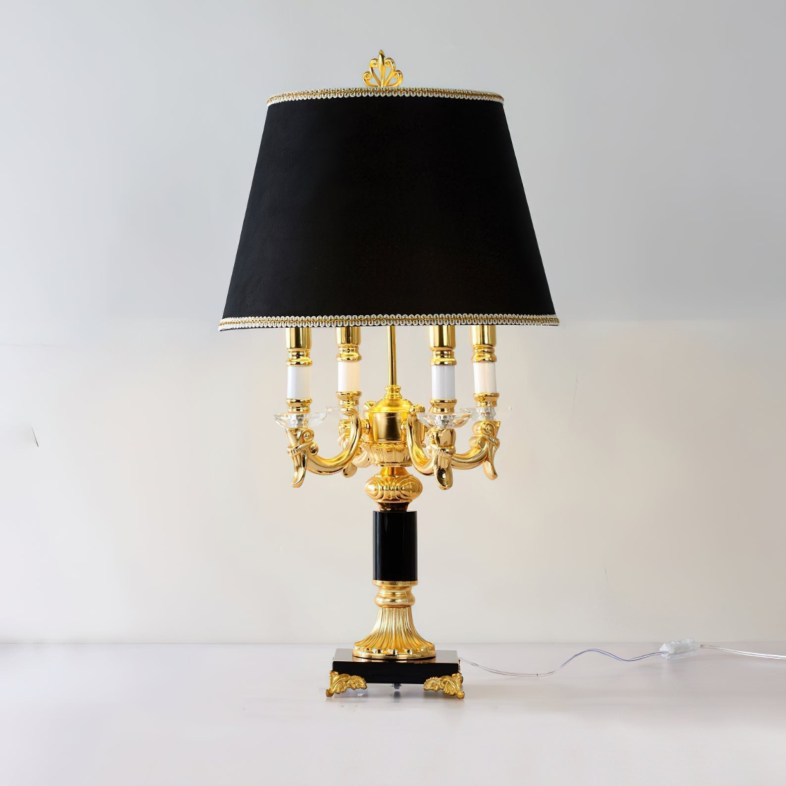 The Sens Table Lamp casting dramatic shadows in a dimly lit room.