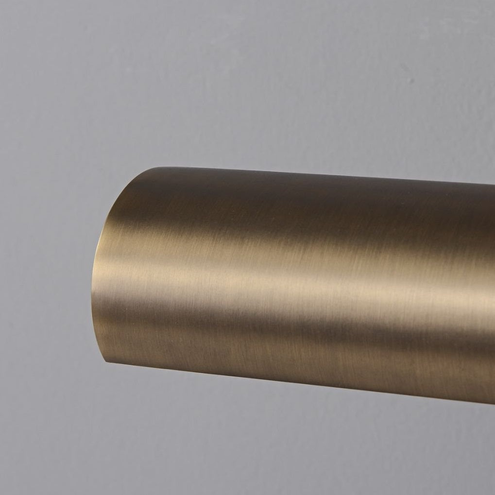 The Steamer Wall Sconce illuminating a family portrait in an entryway.