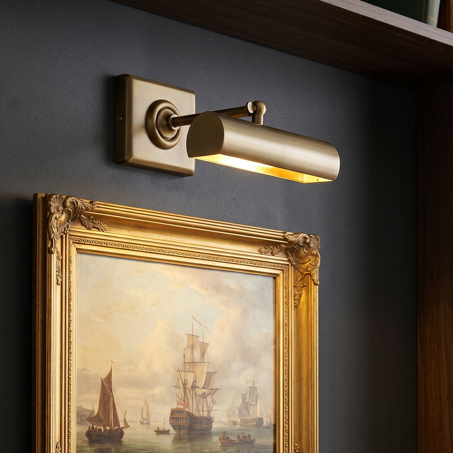 Angled view of the two-headed antique bronze picture light.