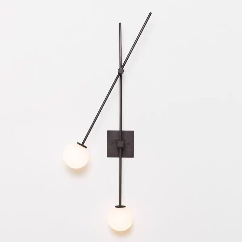 Lifestyle image showing two Tempo Wall Sconces flanking a piece of art in an entryway.