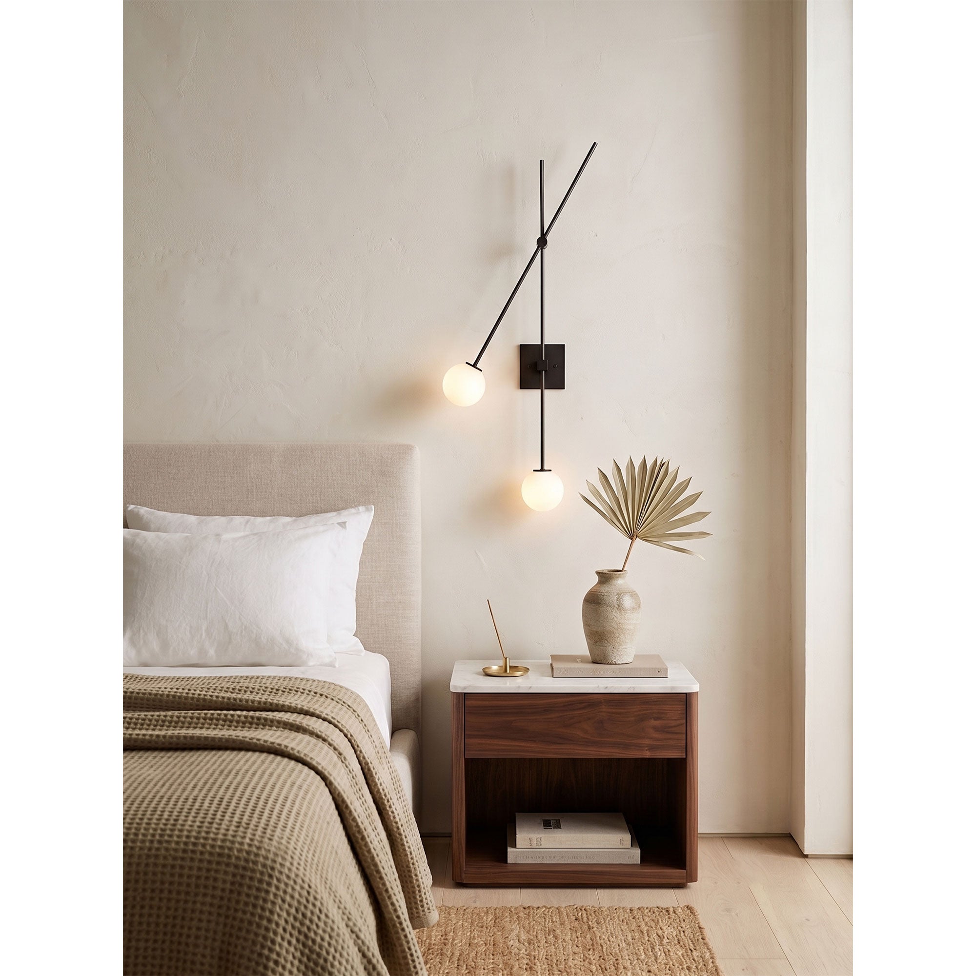 The Tempo Wall Sconce installed as a bedside reading light in a transitional bedroom.