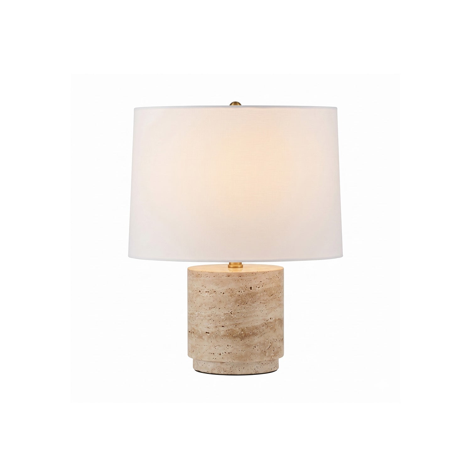 Toby Travertine Table Lamp with its fabric shade lit, showcasing its warm glow.