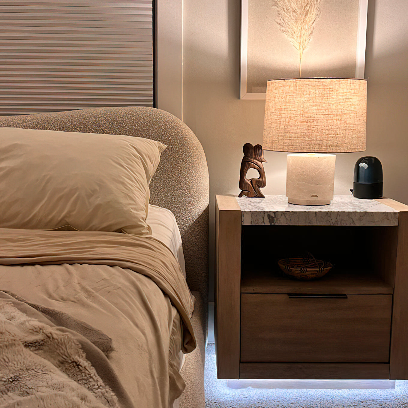 Side profile of the Toby Travertine Table Lamp on a bedroom nightstand.