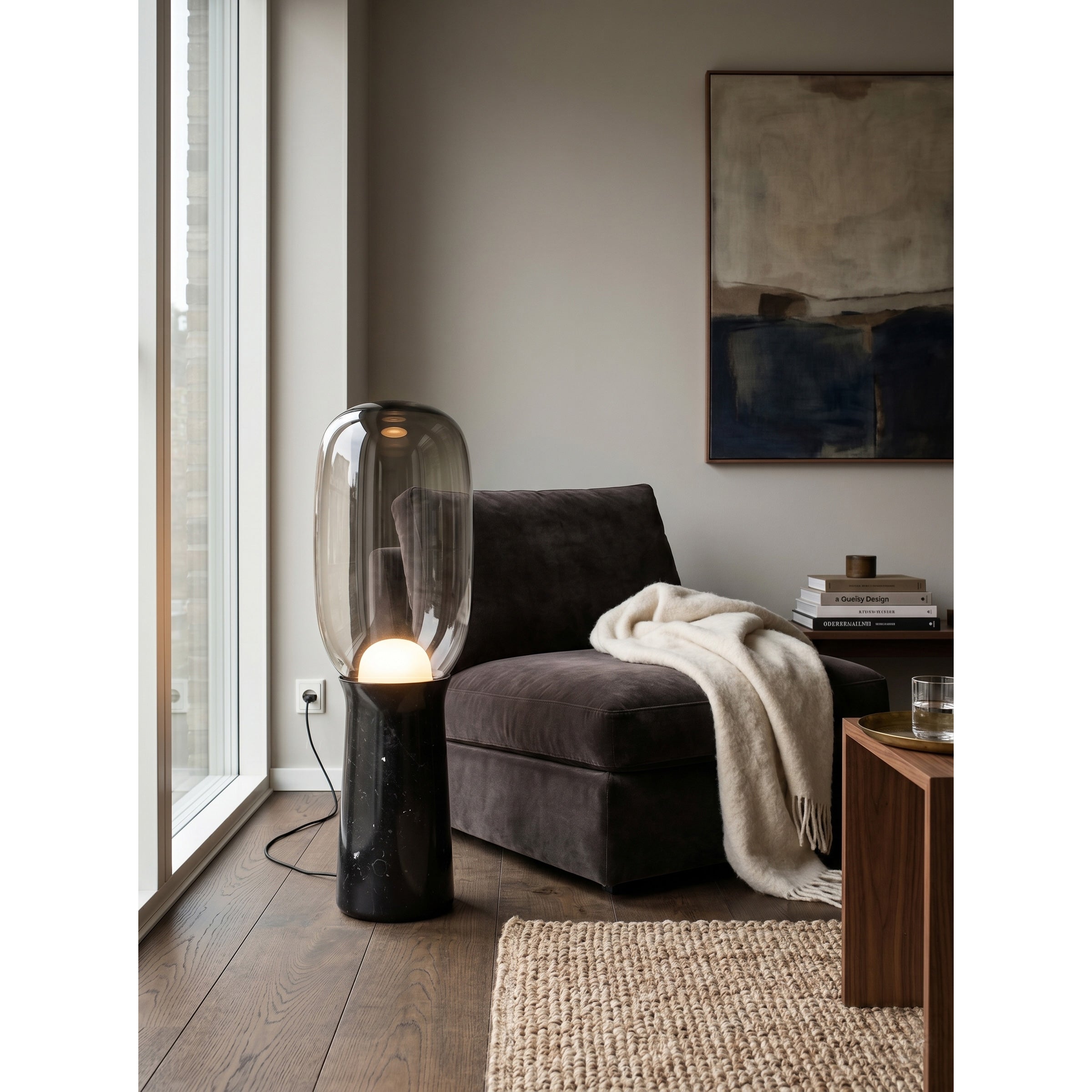 The lamp's solid stone base resting on a hardwood floor.