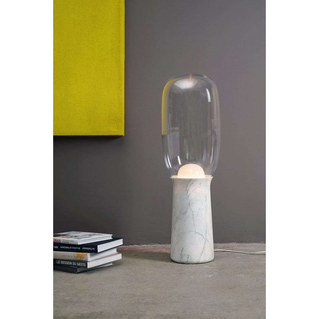 The lamp used as a statement piece next to a contemporary sofa.