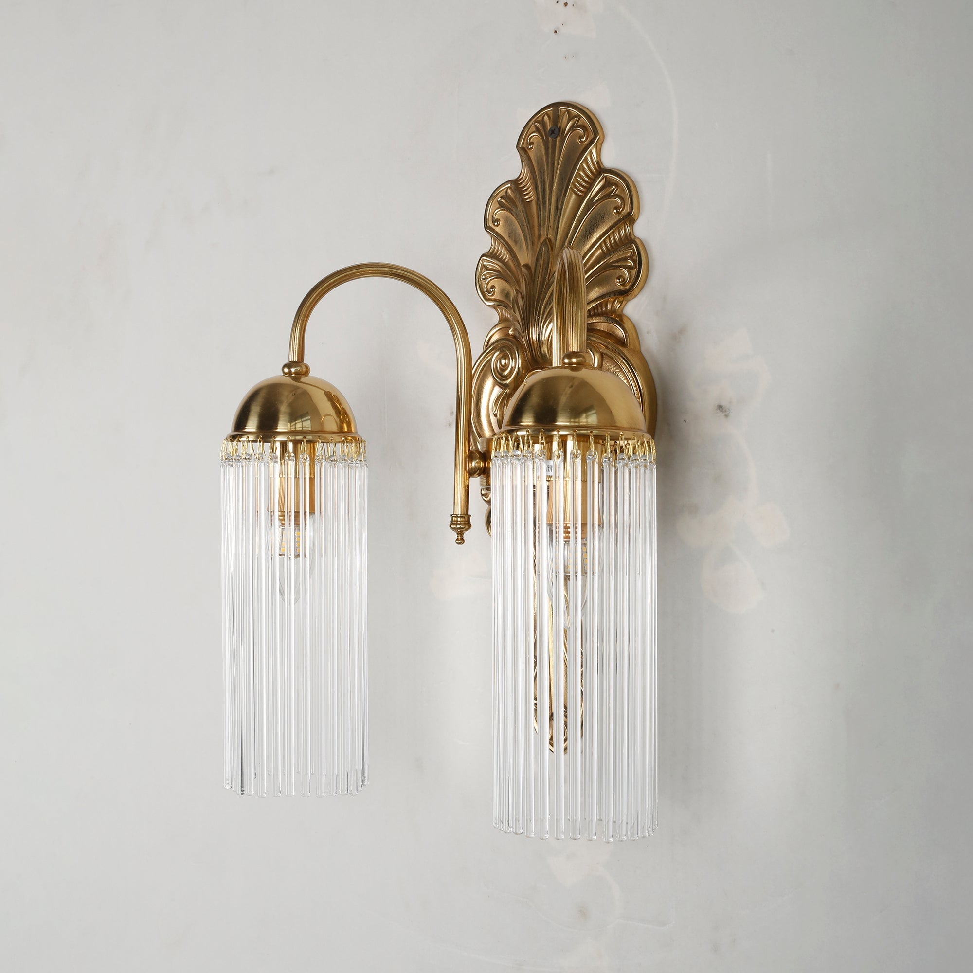Unboxing view showing the Triest Wall Sconce and included mounting hardware.
