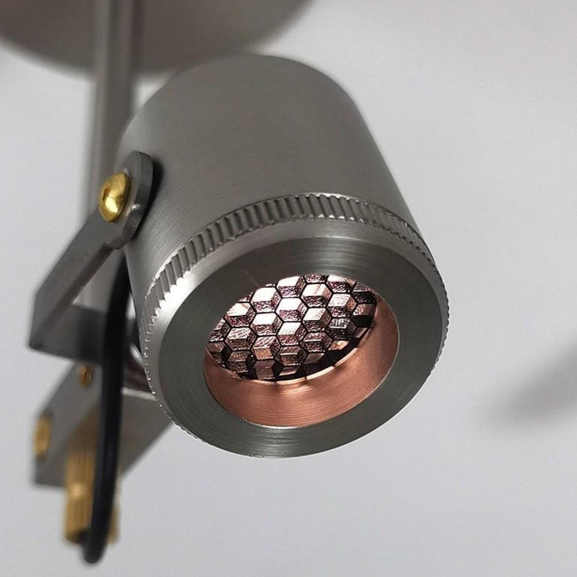 The Triton LED Flush Mount against a dark background to highlight its form.