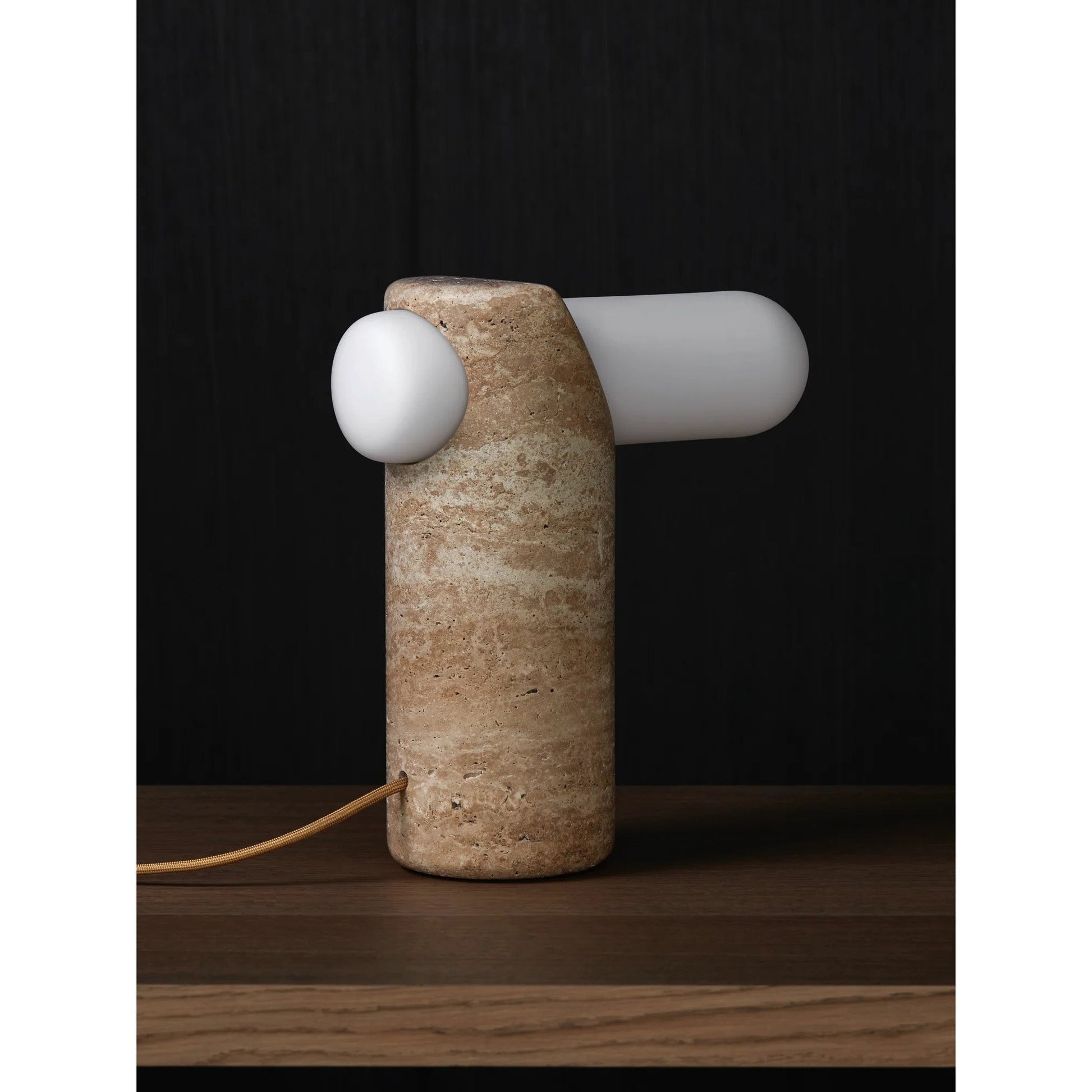 The lamp against a dark background to emphasize its warm glow.