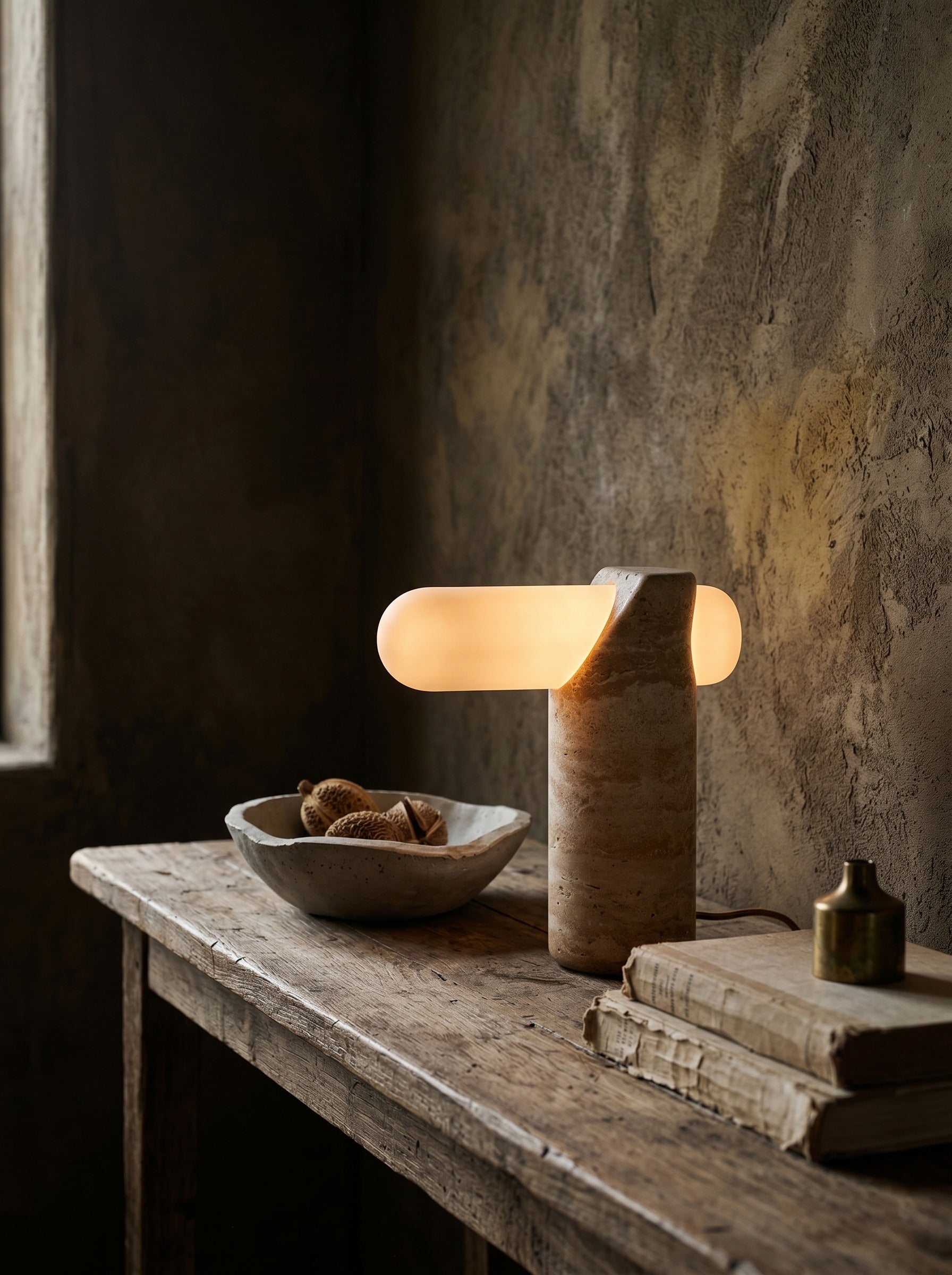Close-up of the frosted glass capsule piercing the travertine base.