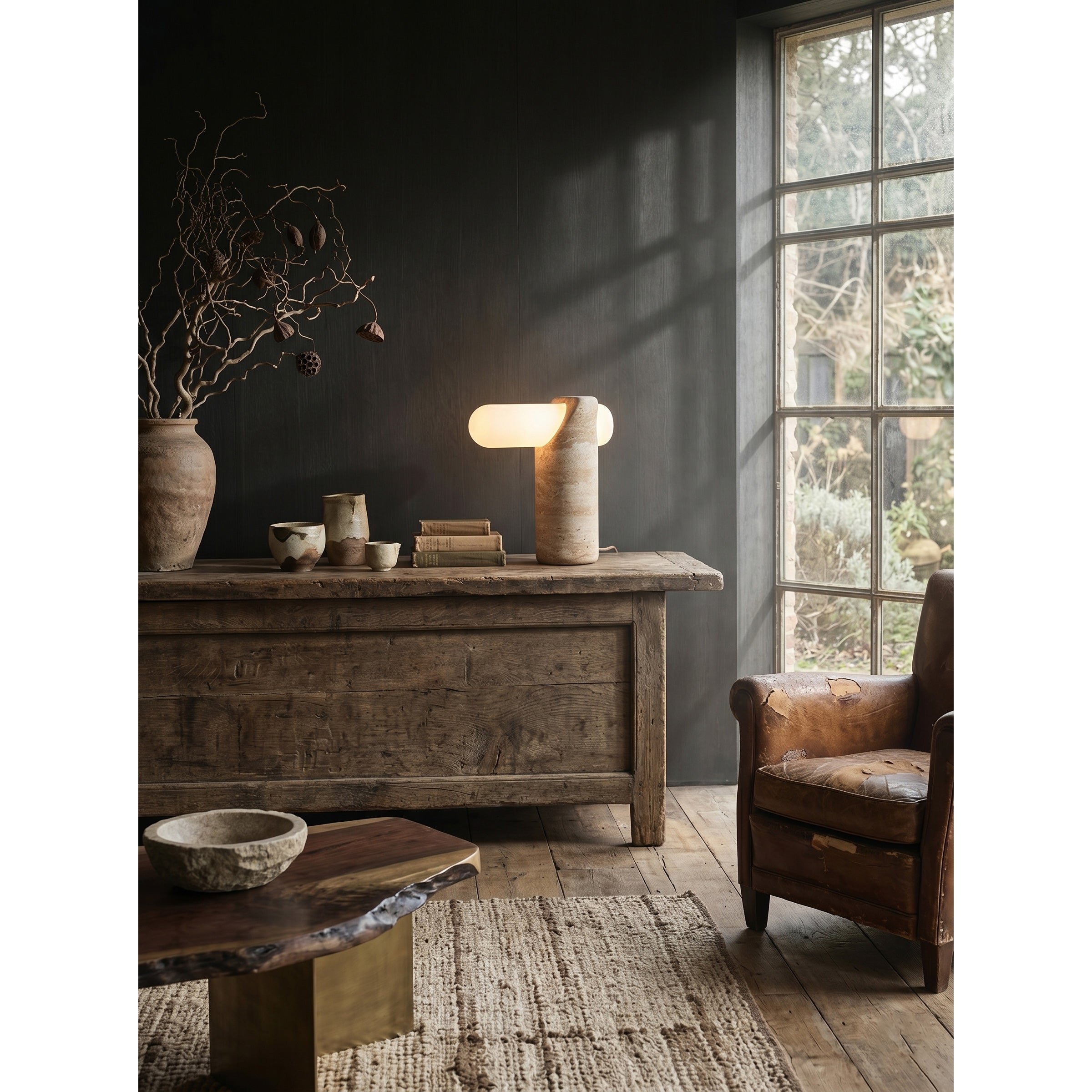 VIA Travertine Table Lamp styled on a living room credenza.