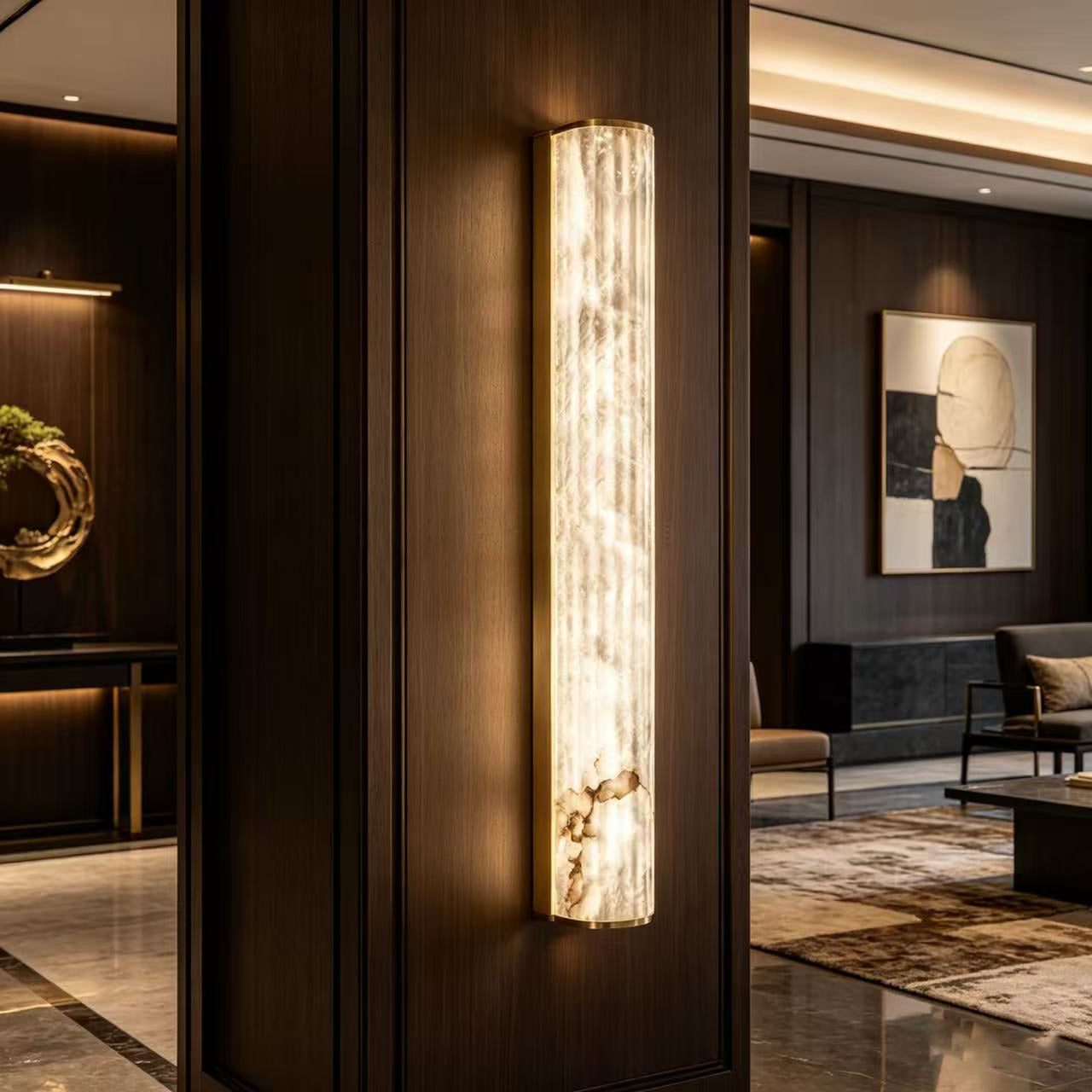 A pair of vertical alabaster sconces installed on either side of a modern bathroom mirror.