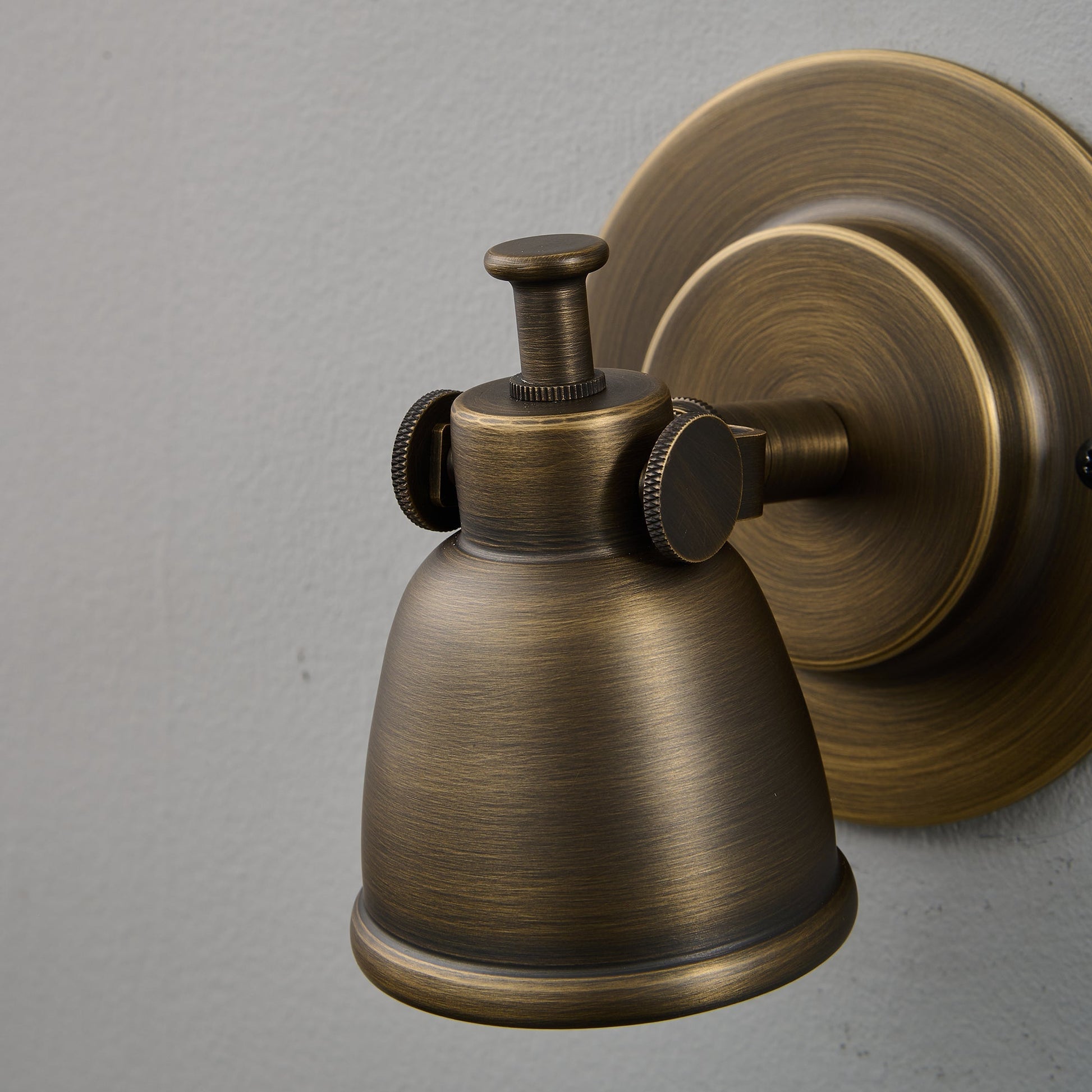 The sconce casting a focused beam of light downwards.