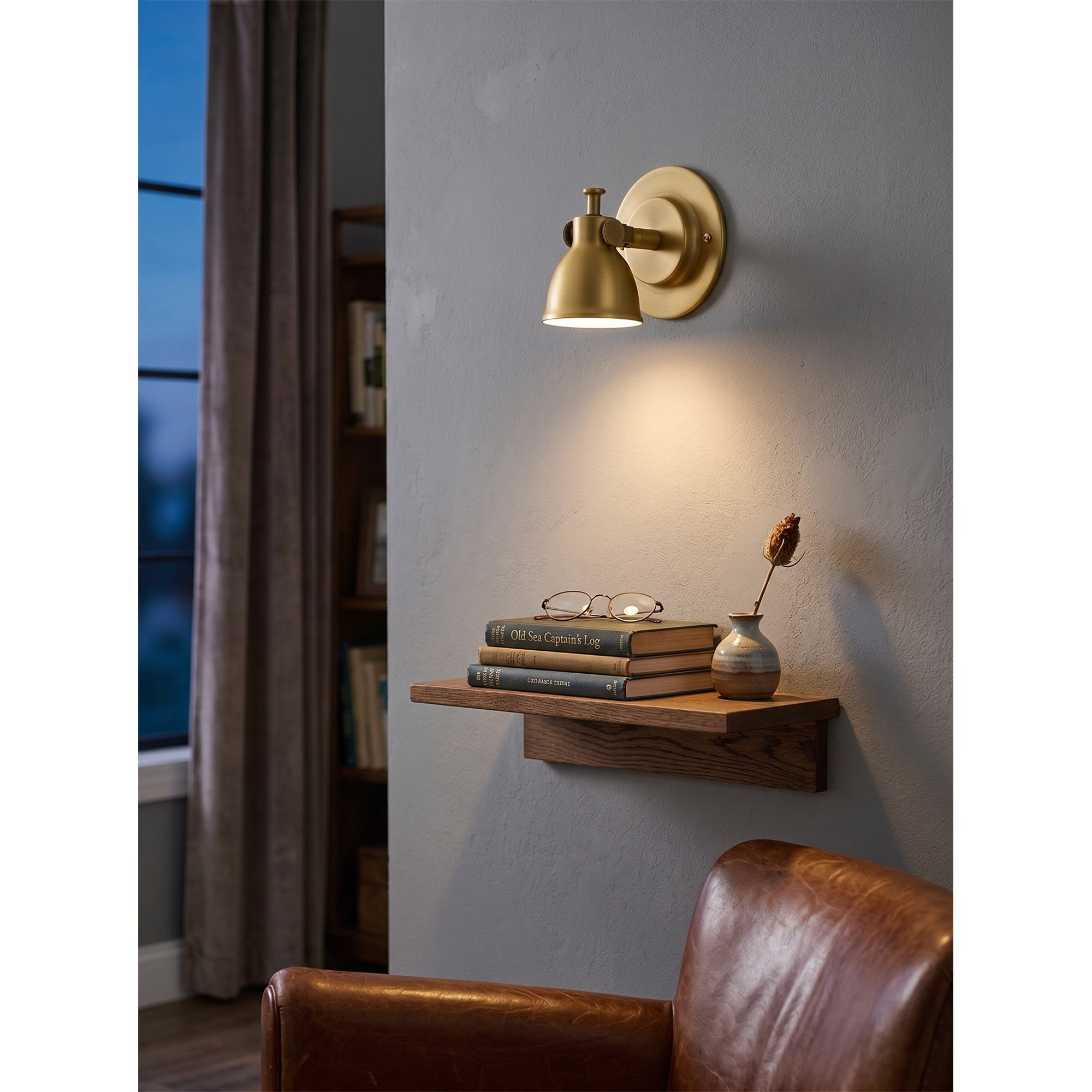 Angled view of the brass Waldo Wall Sconce, highlighting its metallic sheen.