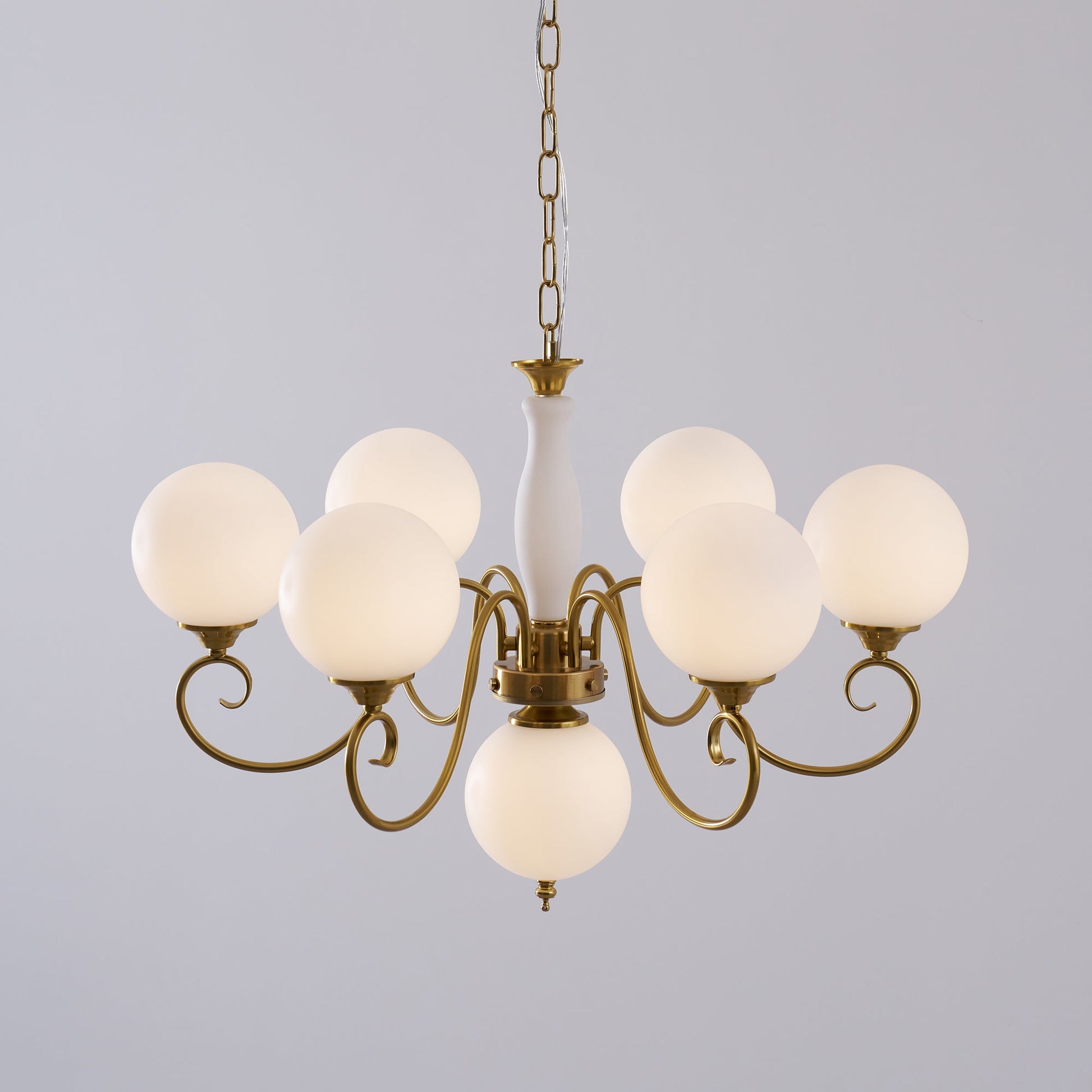 The chandelier's light creating patterns on the ceiling.