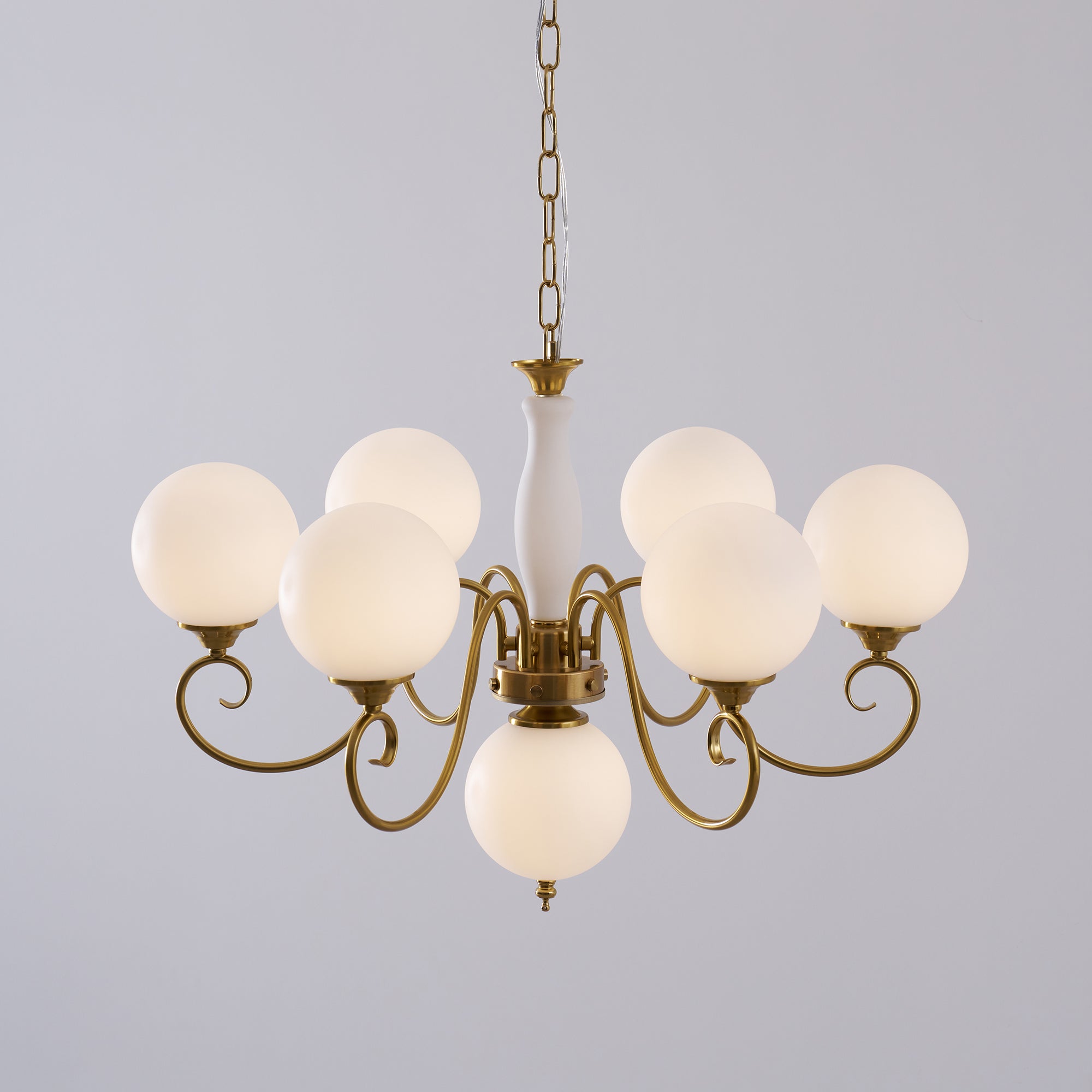 The chandelier's light creating patterns on the ceiling.