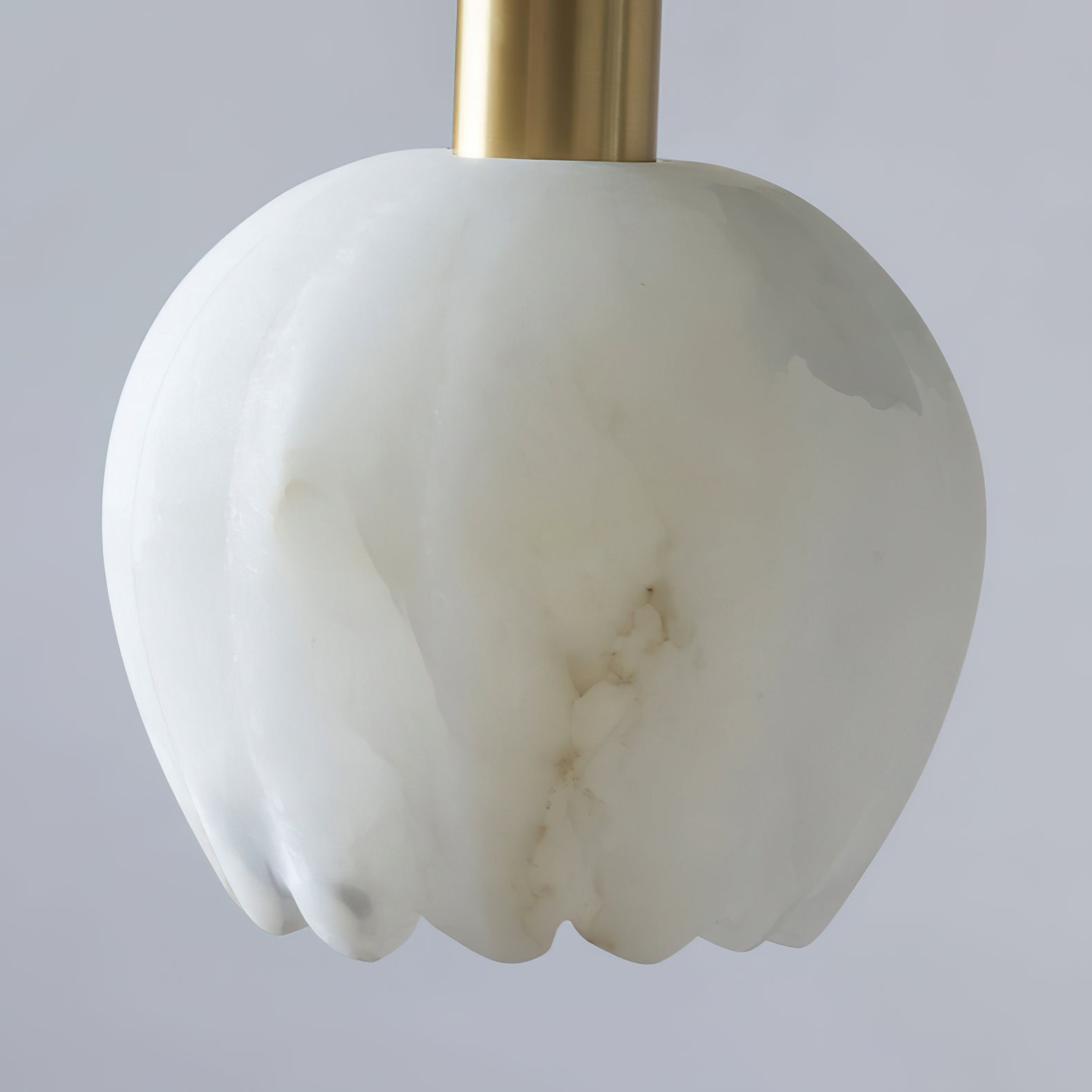 The warm, ethereal ambiance created by the chandelier's light.
