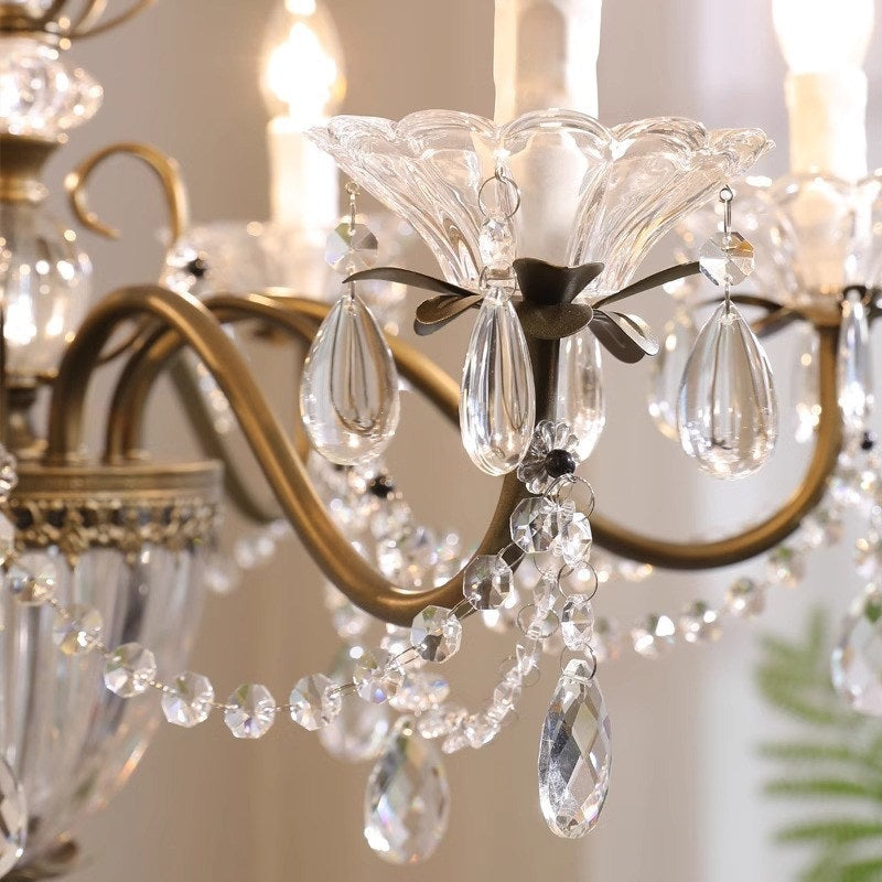 The coffee gold finish of the chandelier's central column and arms.