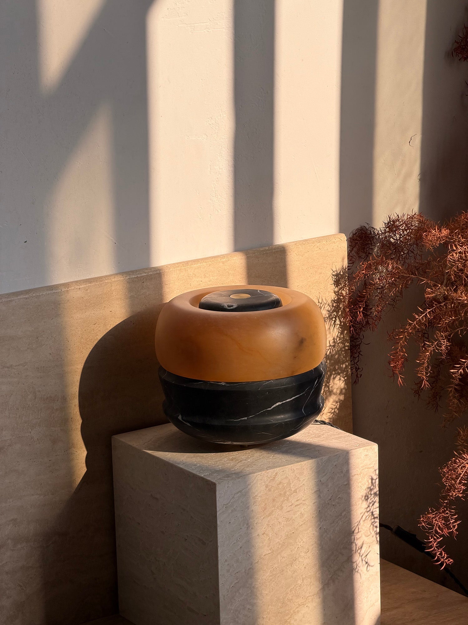 Angled view of the white Ramson Stone Table Lamp.