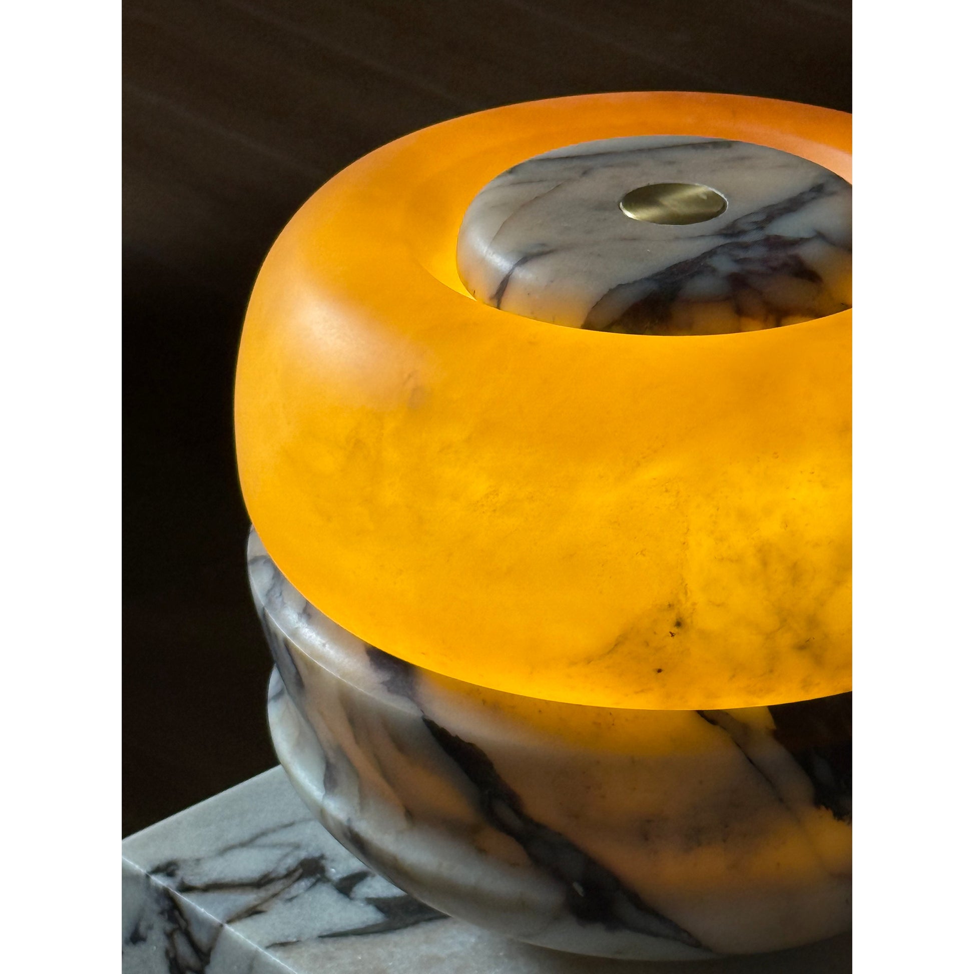 The lamp illuminated in a dimly lit room.