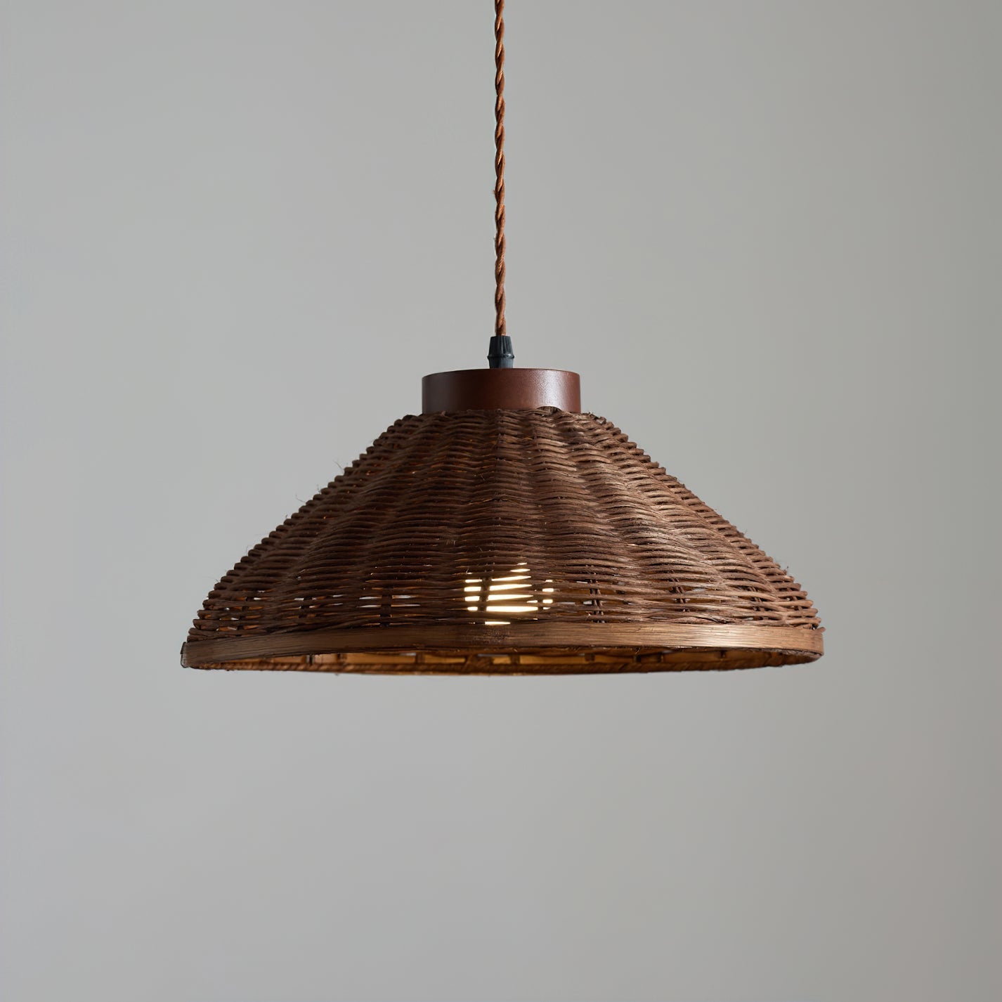 The light diffusion pattern created by the woven rattan shade on a nearby wall.