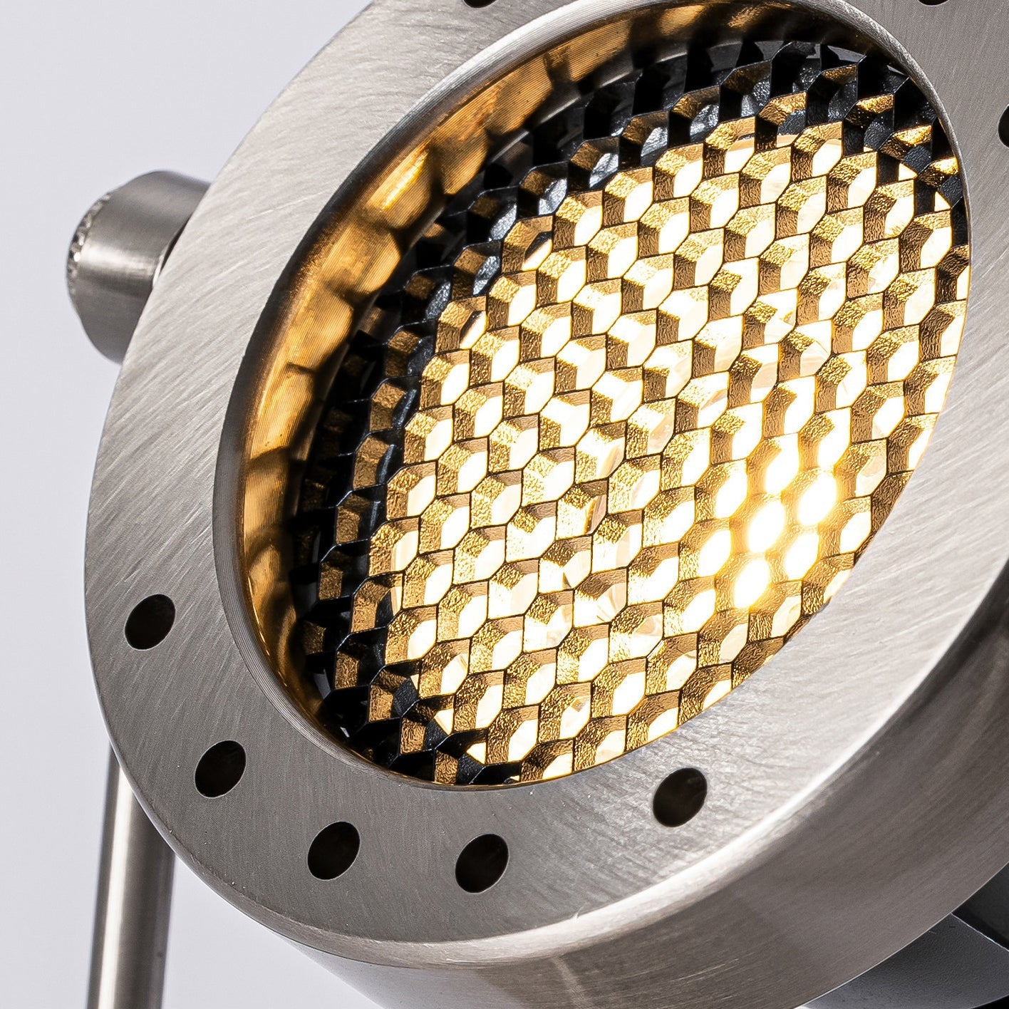 The Reznor wall sconce from a low angle, emphasizing its industrial design.