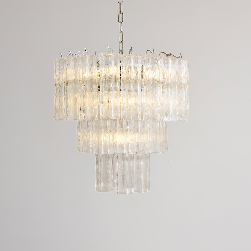Clear glass Rhodes Chandelier against a dark, dramatic wall.