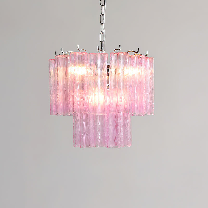 Rhodes Glass Chandelier installed above a bed in a master suite.