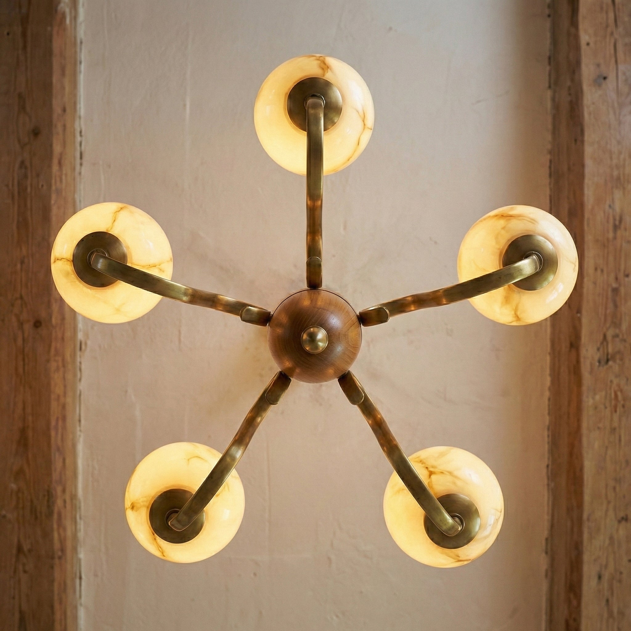Top-down view showing the sunburst symmetry of the chandelier arms.