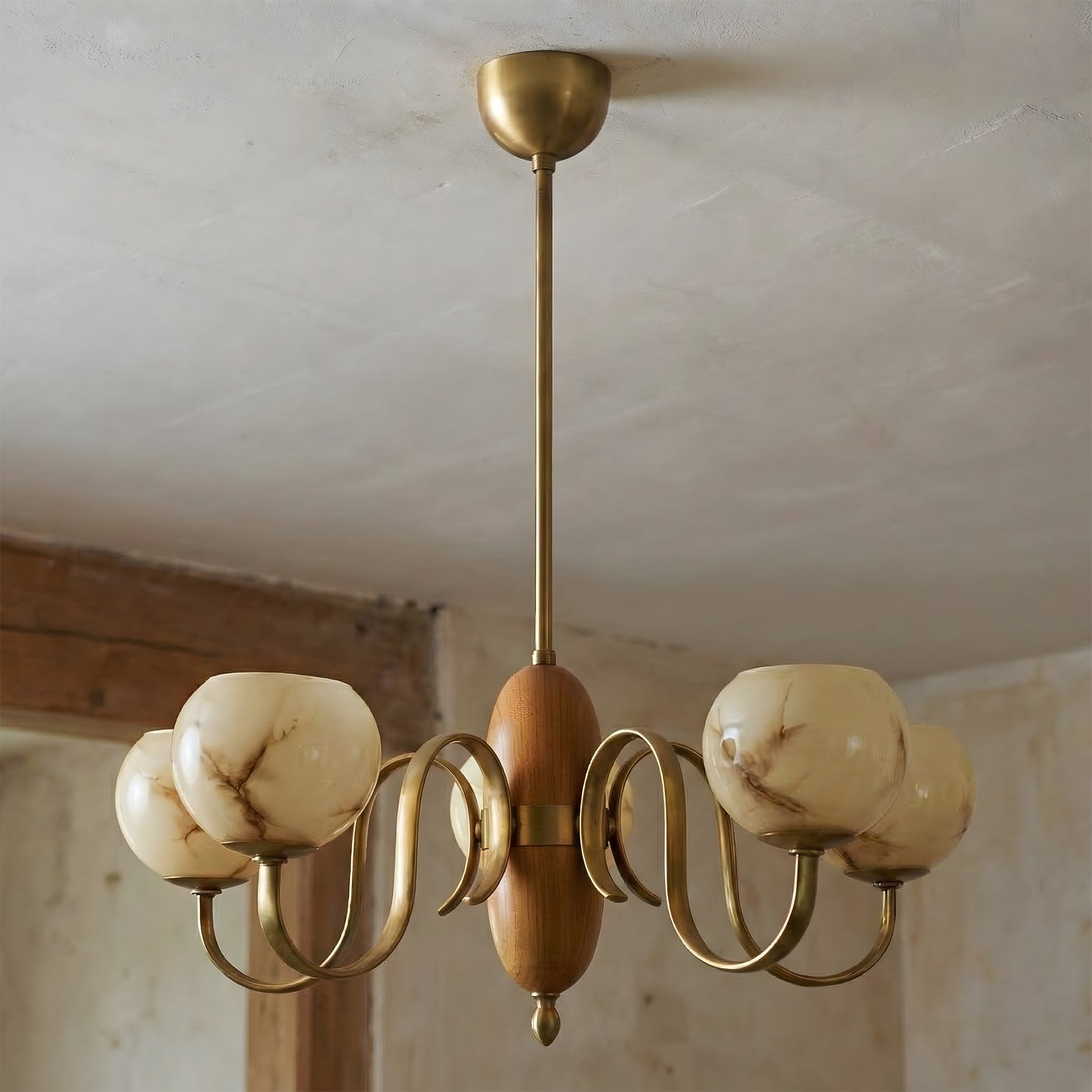 Detail shot of the turned walnut wood hub at the center of the chandelier.
