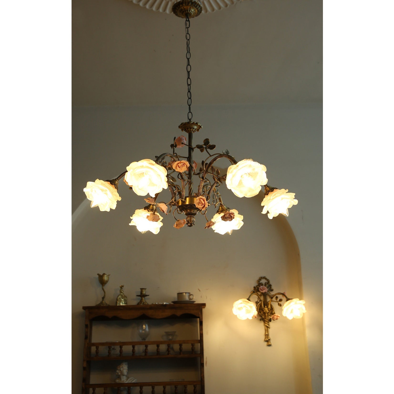 Rosalie Chandelier installed in a cottage-style living room, adding a floral accent.